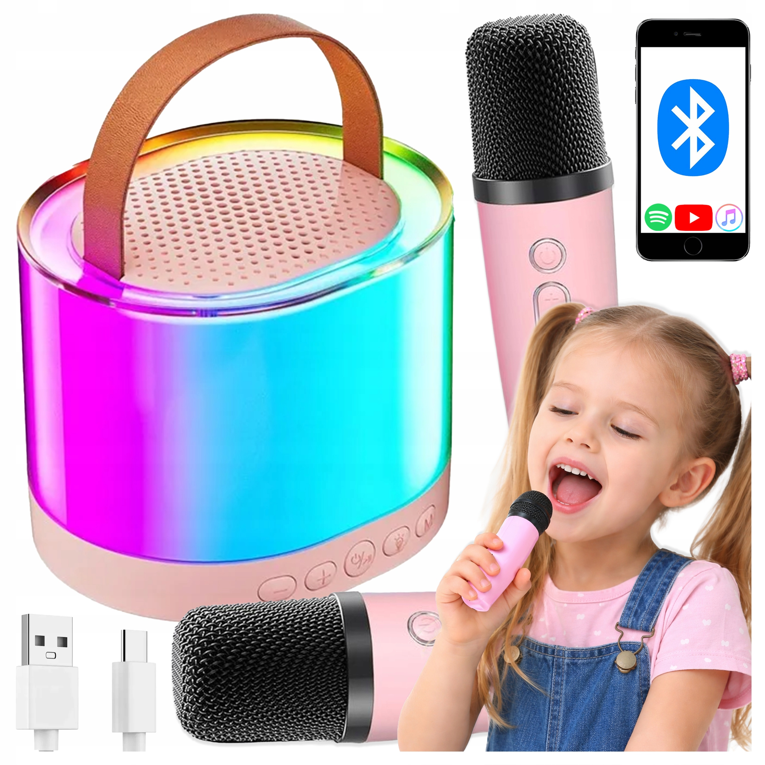 Kolorowy głośnik Bluetooth, dwa różowe mikrofony, kable, smartfon i śpiewająca dziewczynka.
