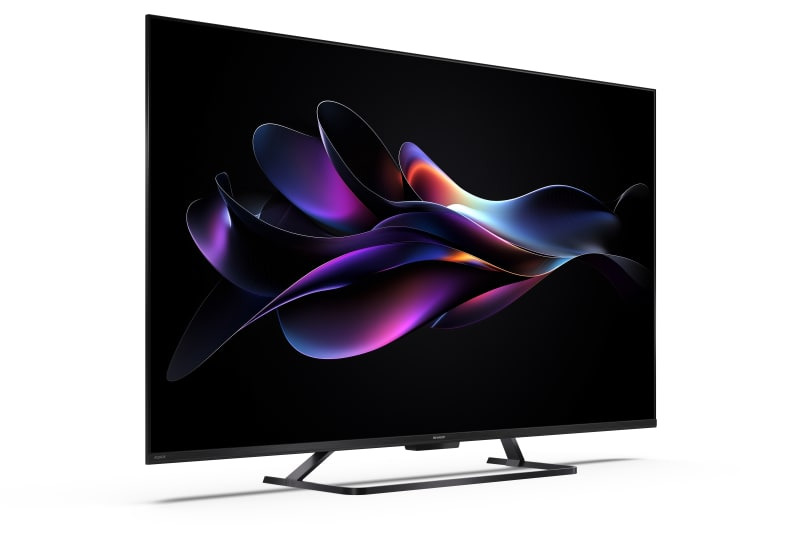 Nowoczesny telewizor w czarnej ramce wyświetla na ekranie kolorową, abstrakcyjną grafikę.