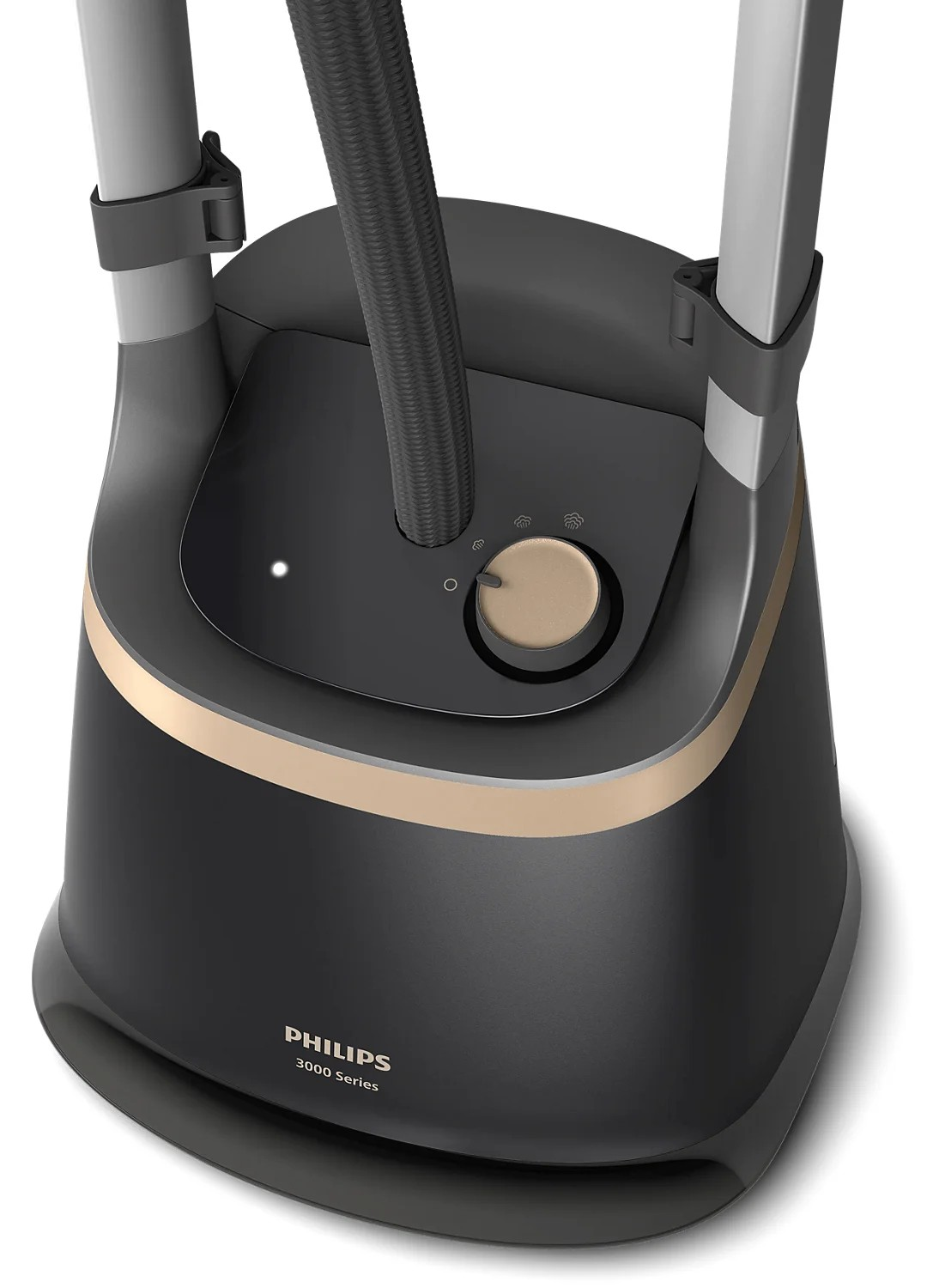 Közelkép egy fekete Philips 3000 Series ruhagőzölő alapról arany díszítéssel, vezérlőtárcsával és gőztömlővel.