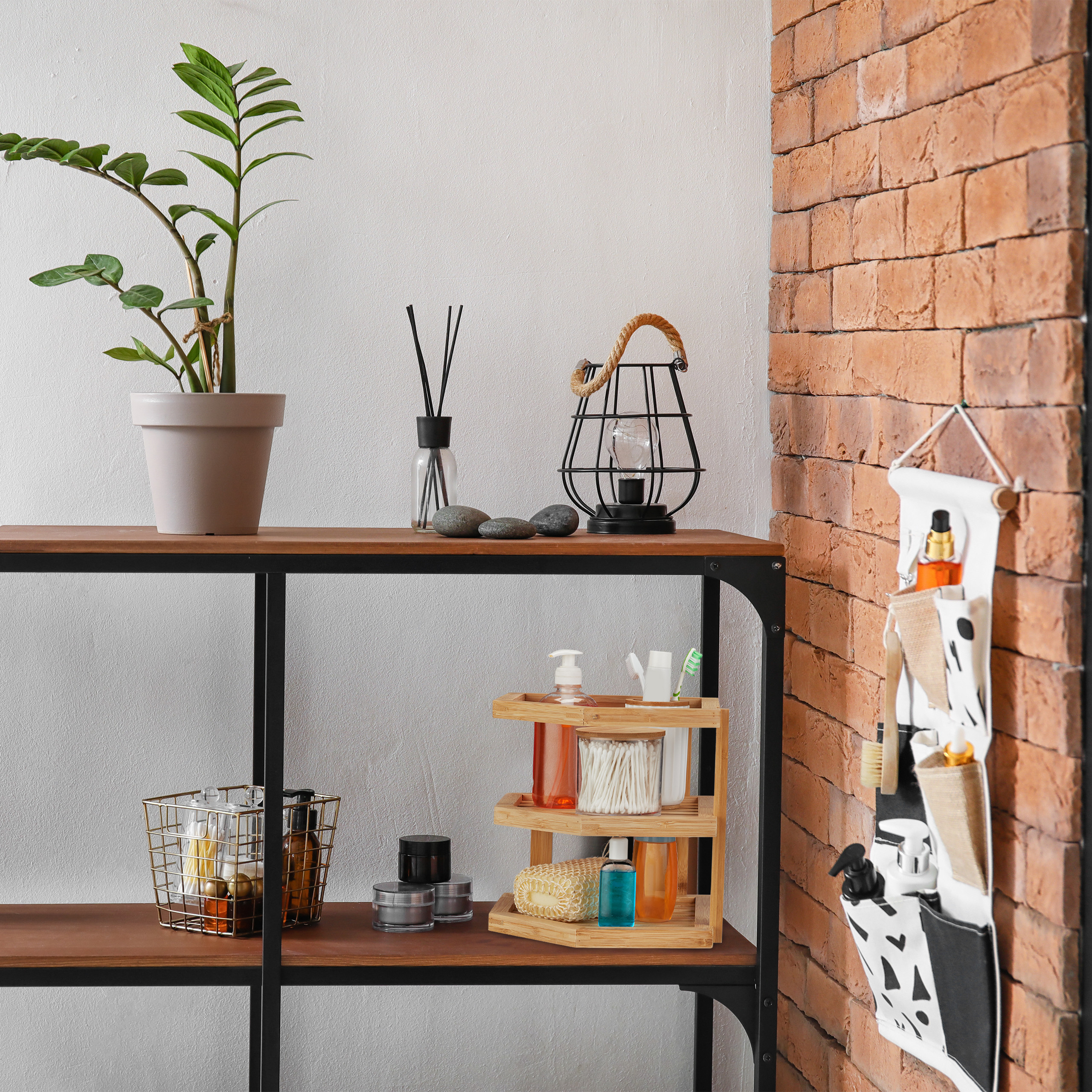 Ein Holzregal mit Pflegeprodukten, Topfpflanze und Lampe steht an einer Backsteinwand.