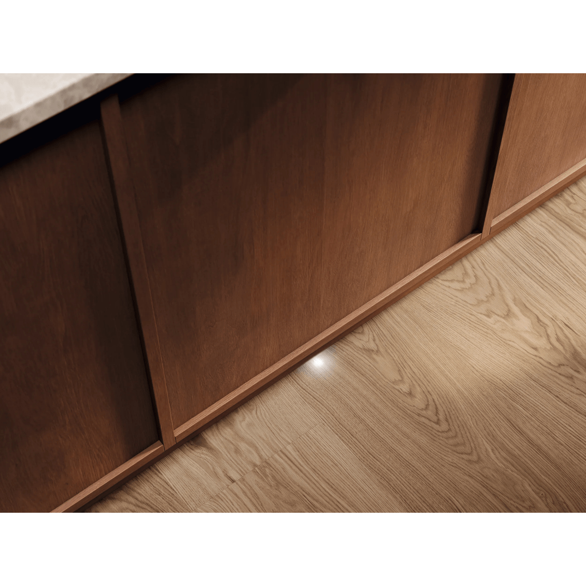 Una base di mobile in legno su pavimento chiaro con una piccola luce sotto.