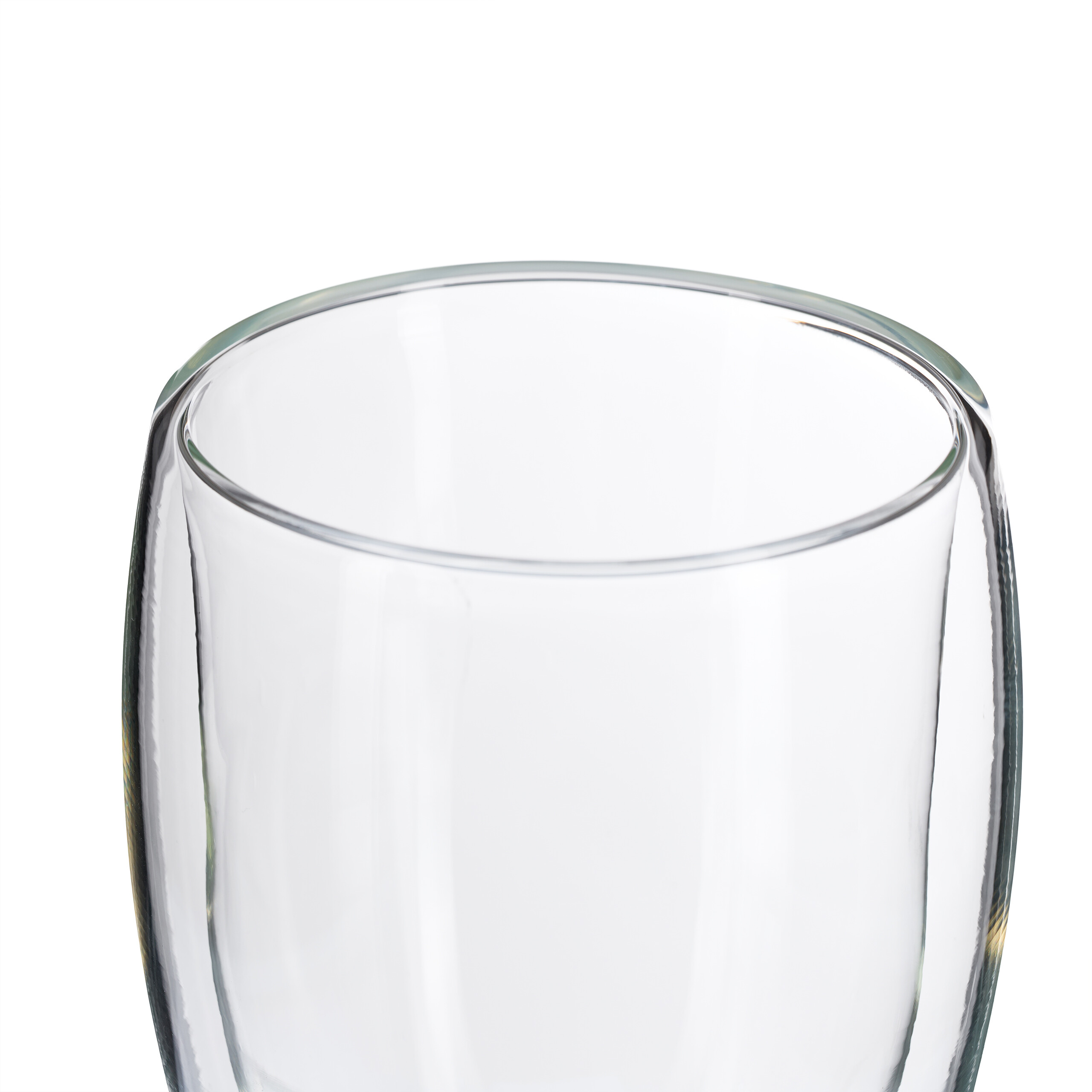 Ein leeres Glas mit doppelten Wänden vor weißem Hintergrund.