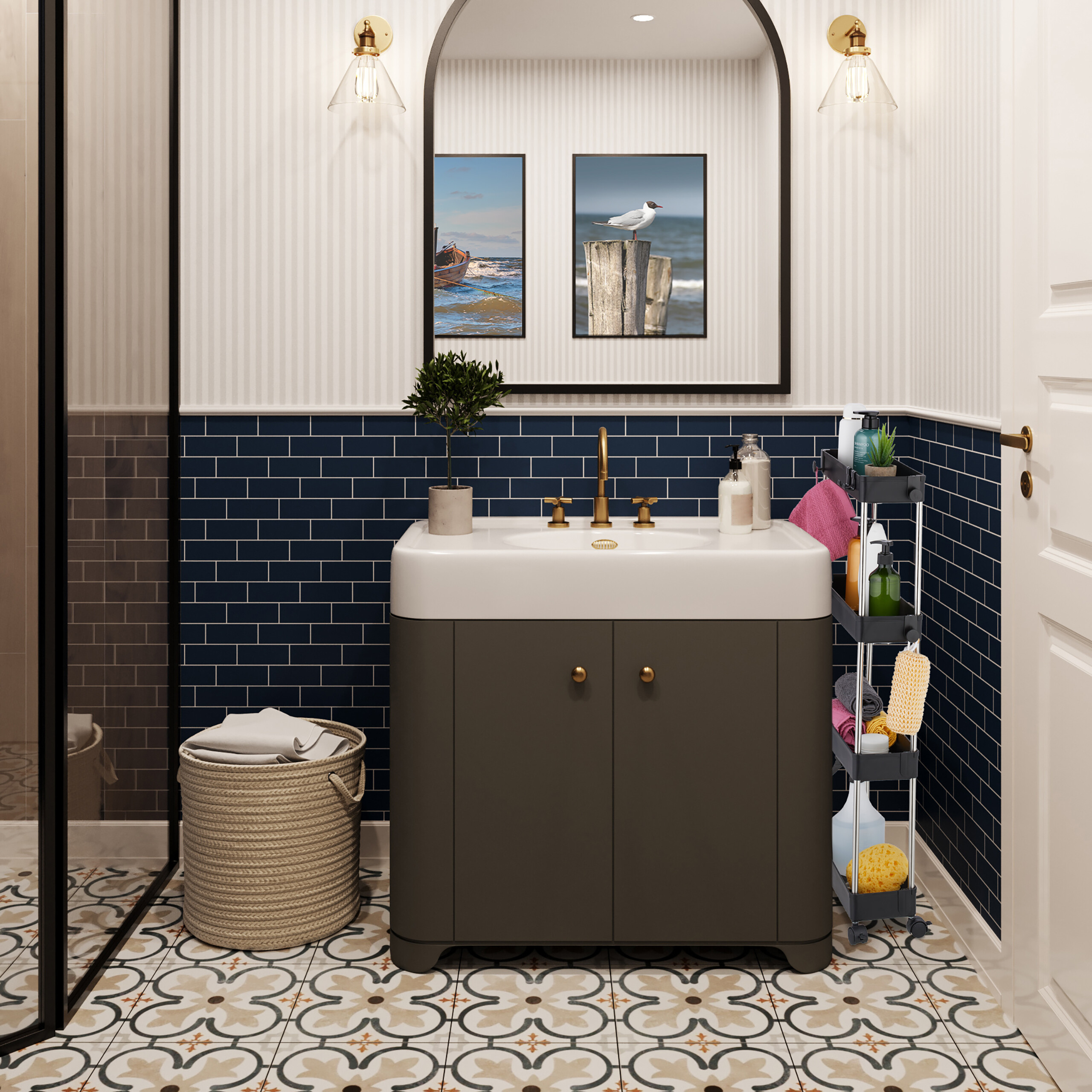 Badezimmer mit Waschbecken, dunkelblauen Fliesen, grauem Schrank, gerahmten Bildern, Spiegel und gefliestem Boden.