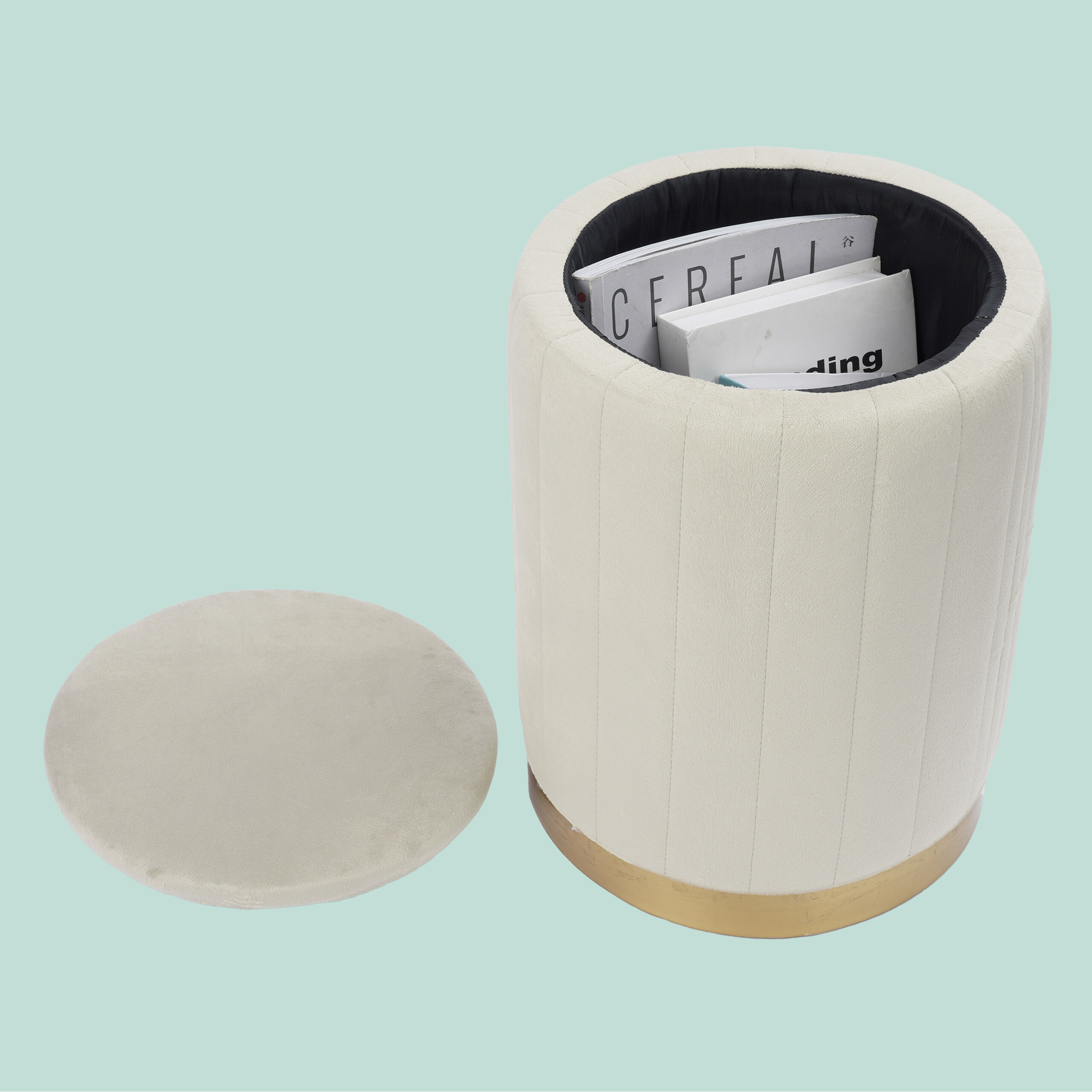 Beige, runder Hocker mit offenem Deckel und darin befindlichen Büchern.