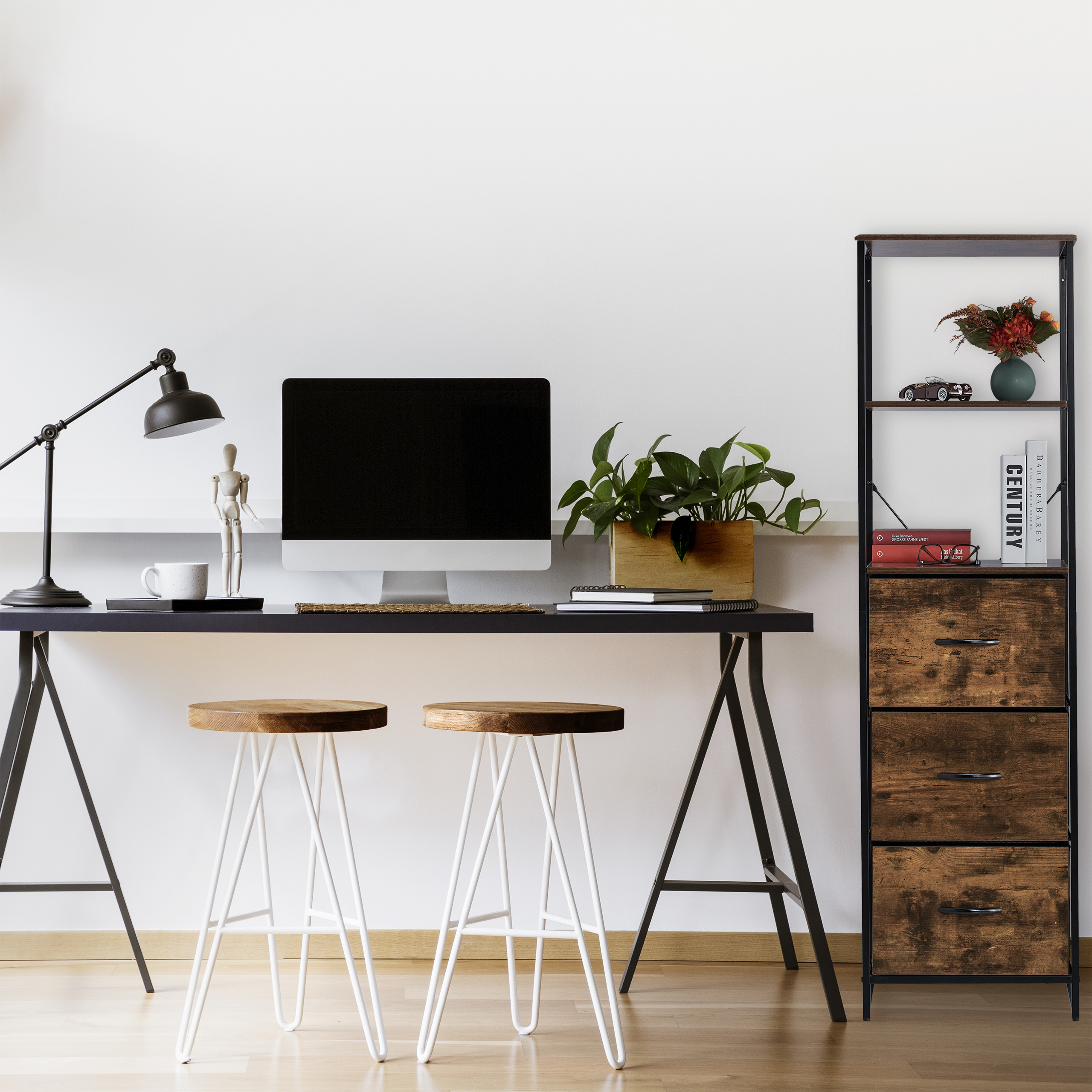 Moderne Schreibtisch-Einrichtung mit Computer, Pflanzen, Lampen und zwei Hockern in einem hellen Raum.