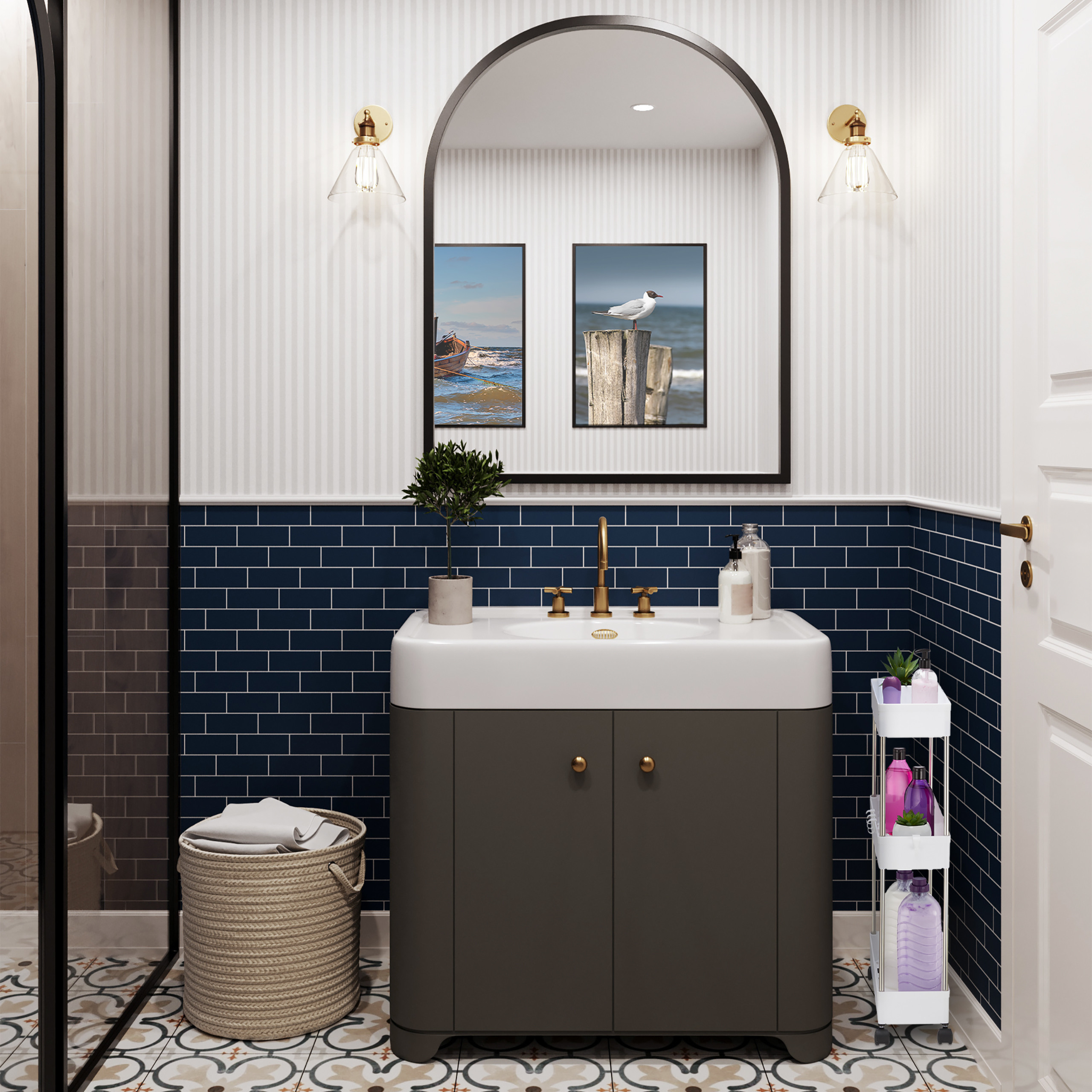 Badezimmer mit weißem Waschbecken, grauem Unterschrank, blauen Fliesen, Bogen-Spiegel, Wandleuchten und Wäschekorb.