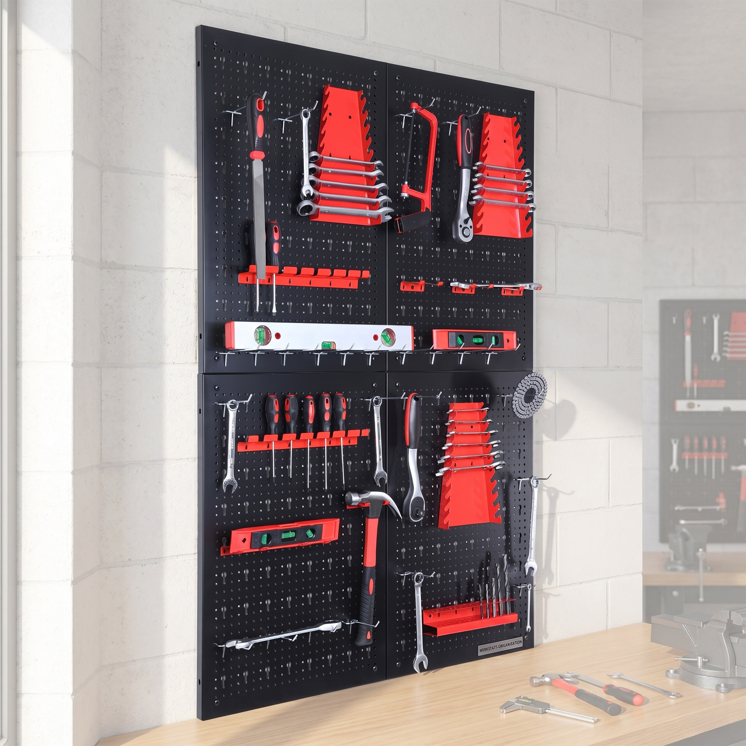 Schwarze Lochwand mit roten Halterungen, bestückt mit Werkzeugen wie Hämmern, Schraubenschlüsseln und Zangen.