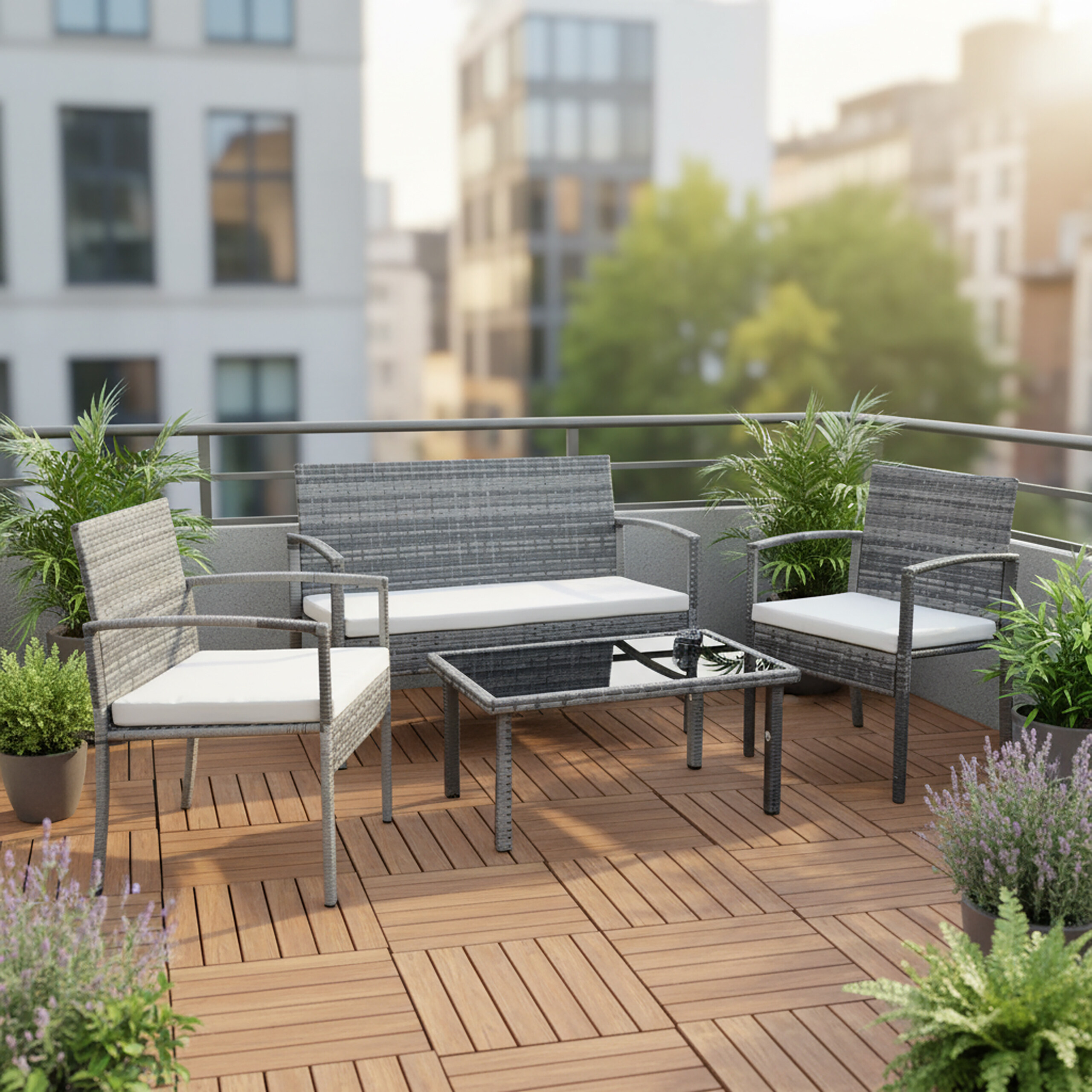 Moderne graue Rattan-Terrassenmöbel mit weißen Kissen und Pflanzen auf Holzterrasse.