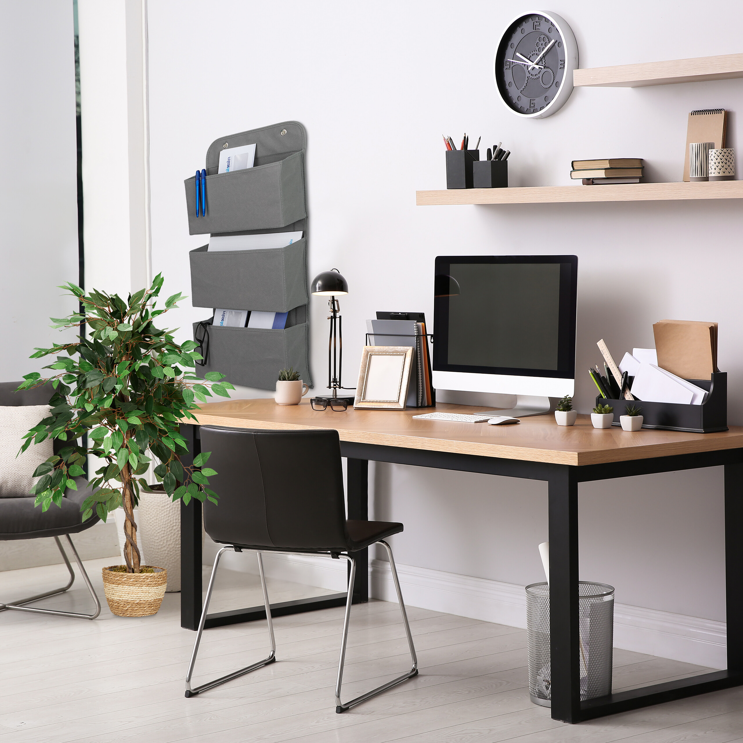 Ein modernes Büro mit Holztisch, Computer, schwarzem Stuhl, Regalen, Wanduhr und Hänge-Organizer.
