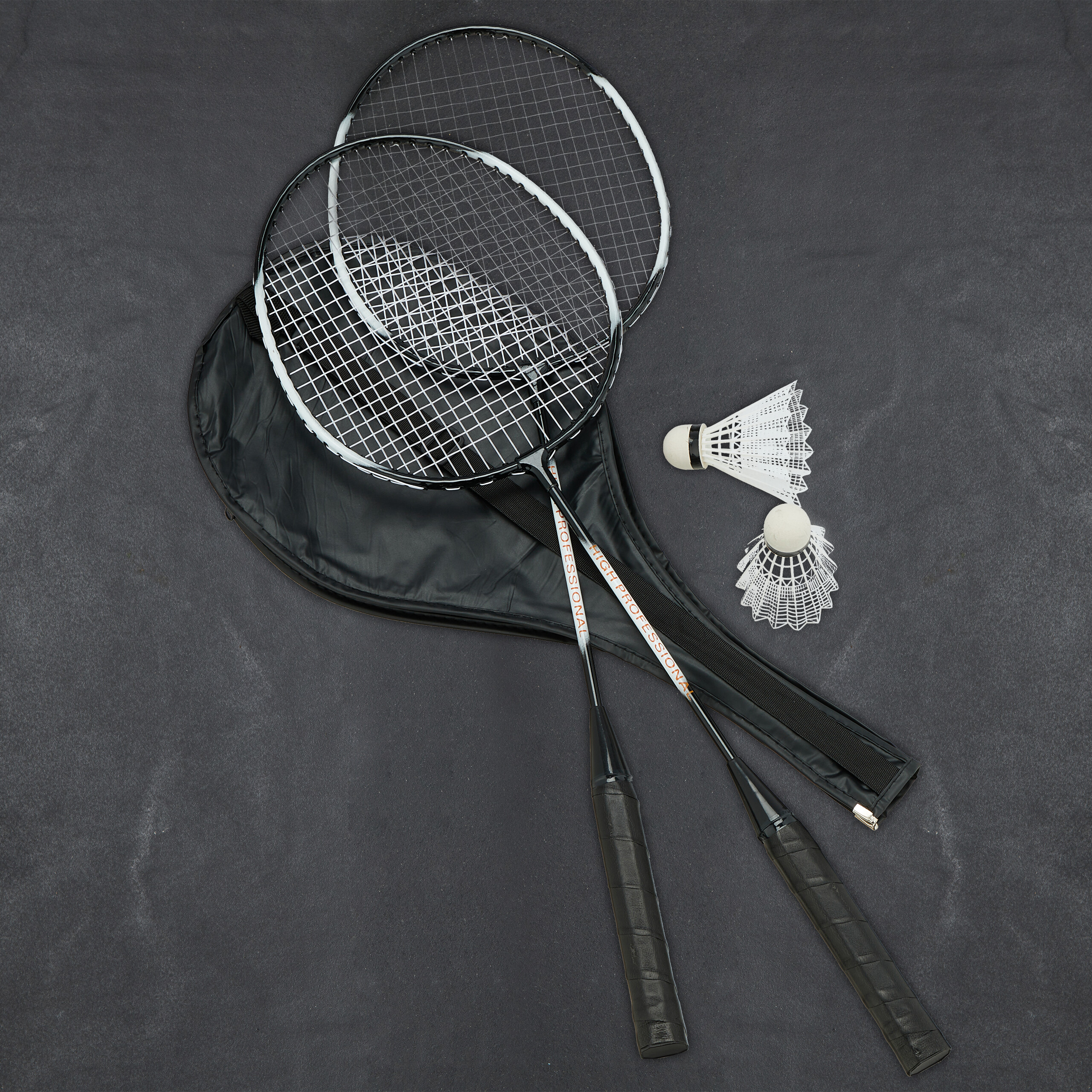 Zwei Badminton-Schläger, eine Tasche und zwei Federbälle auf dunklem Untergrund.