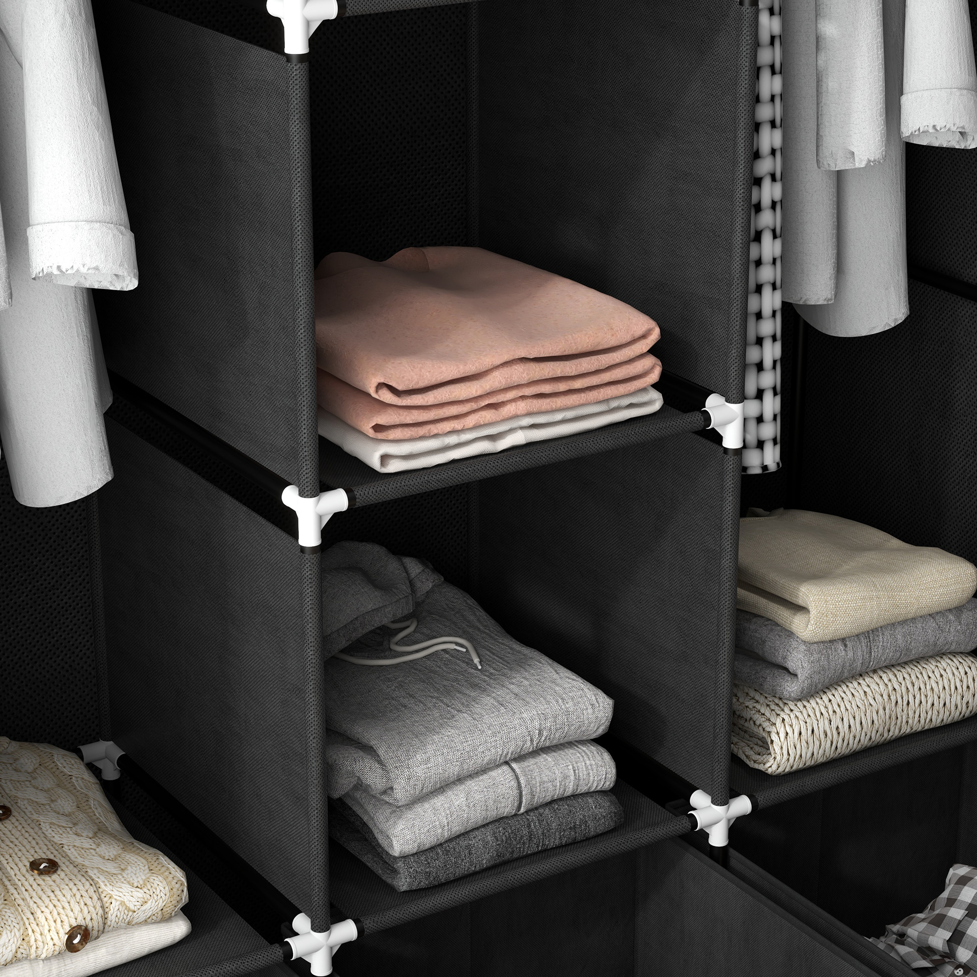 Un armario modular de tela negra con suéteres doblados en estantes y ropa colgada.