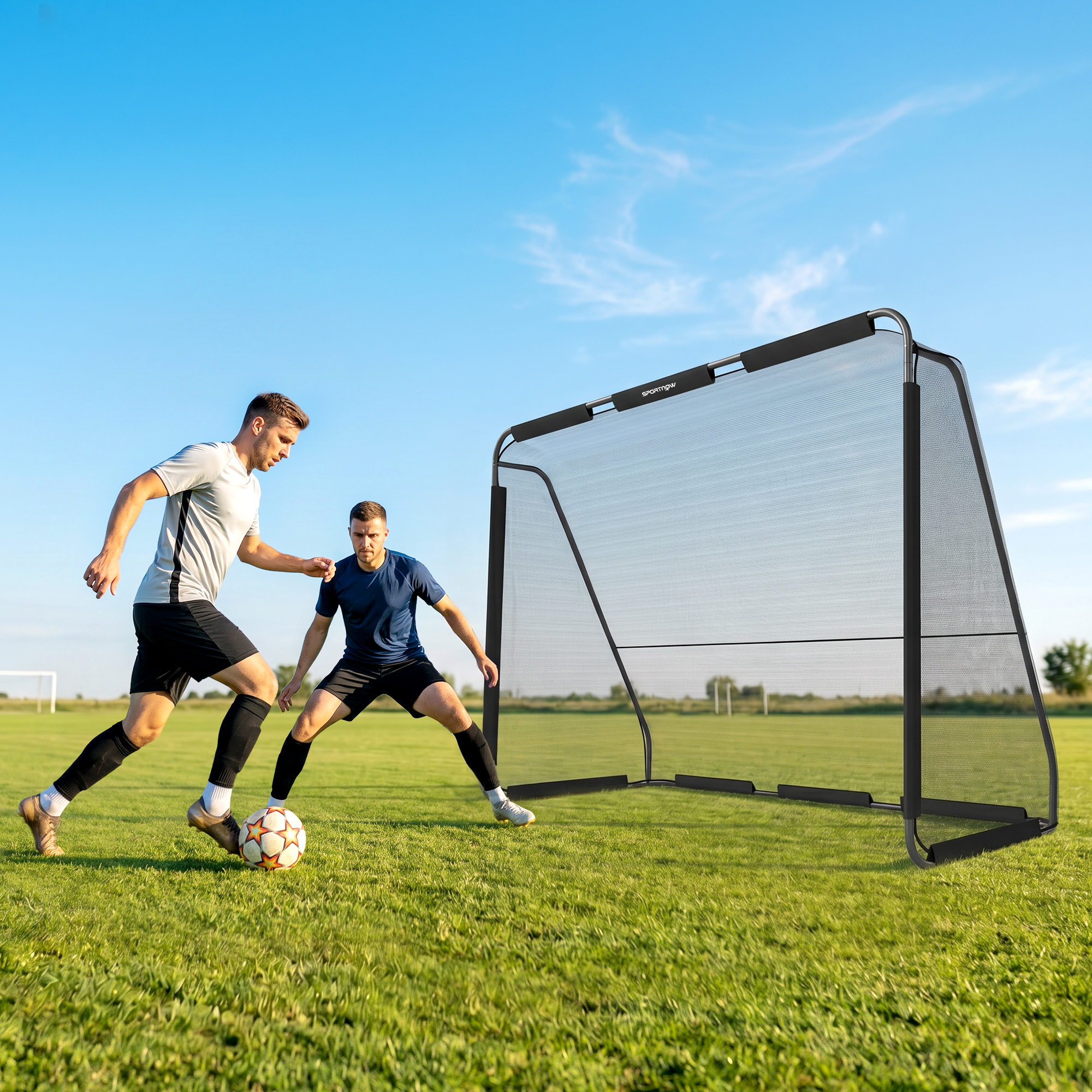 Dos hombres juegan al fútbol en un campo de césped frente a una portería negra bajo un cielo azul.