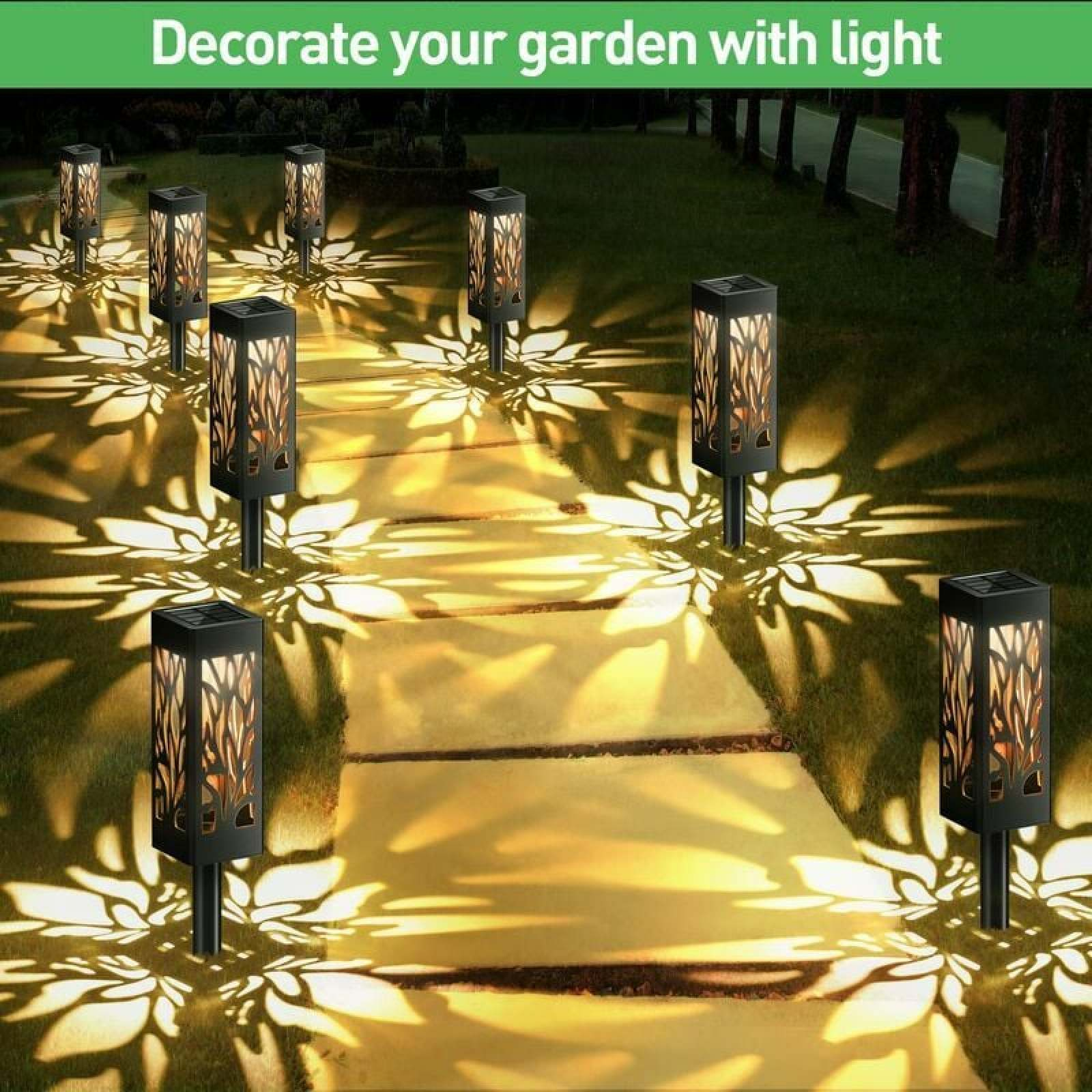 Solarbetriebene Gartenlaternen beleuchten einen Weg mit dekorativen Blumenmustern auf dem Boden.