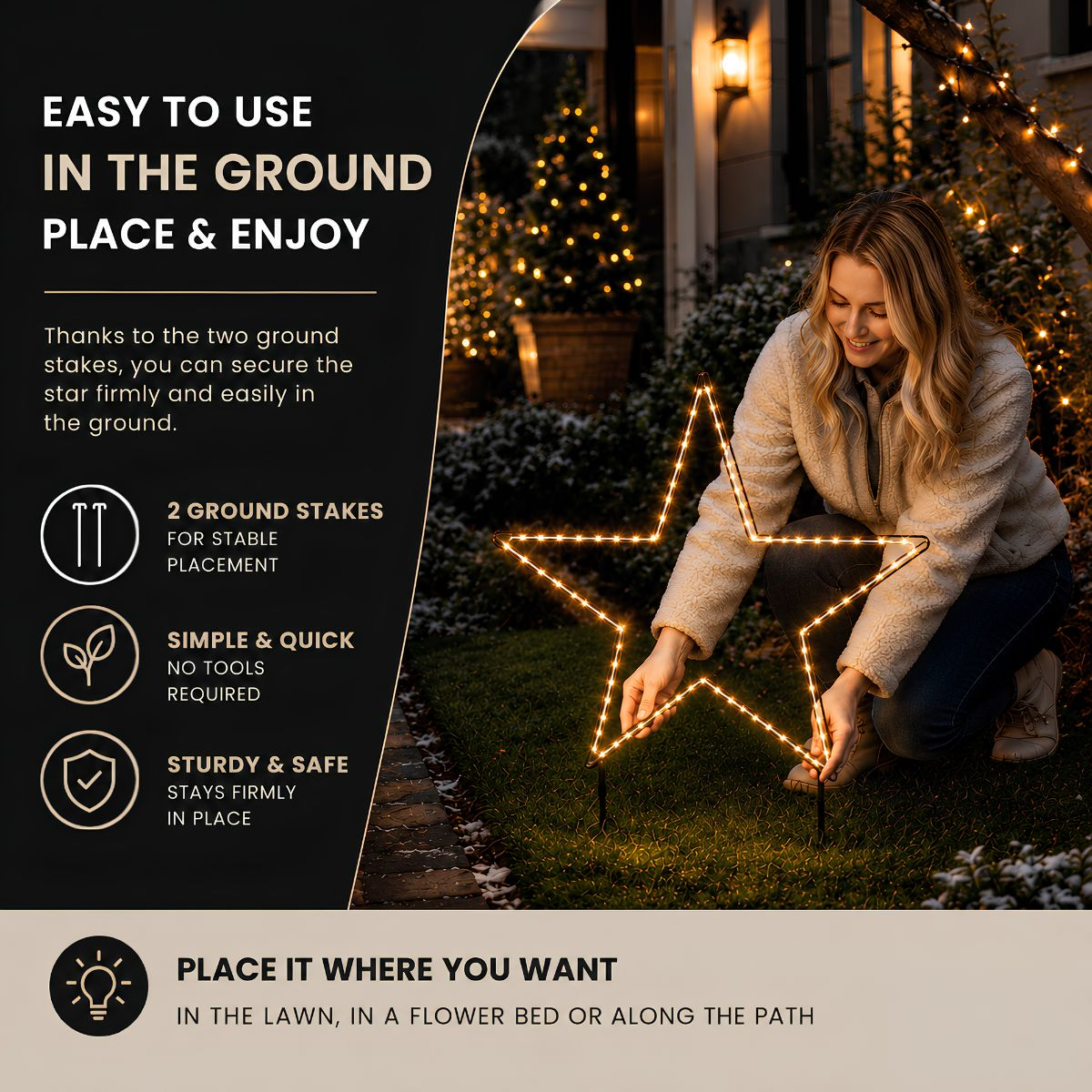 Une femme installe une décoration d'étoile lumineuse avec des piquets.