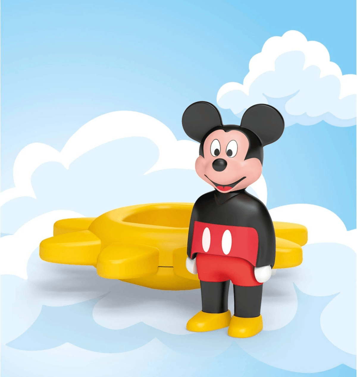Mickey Mouse se encuentra frente a un engranaje amarillo sobre fondo azul con nubes blancas.