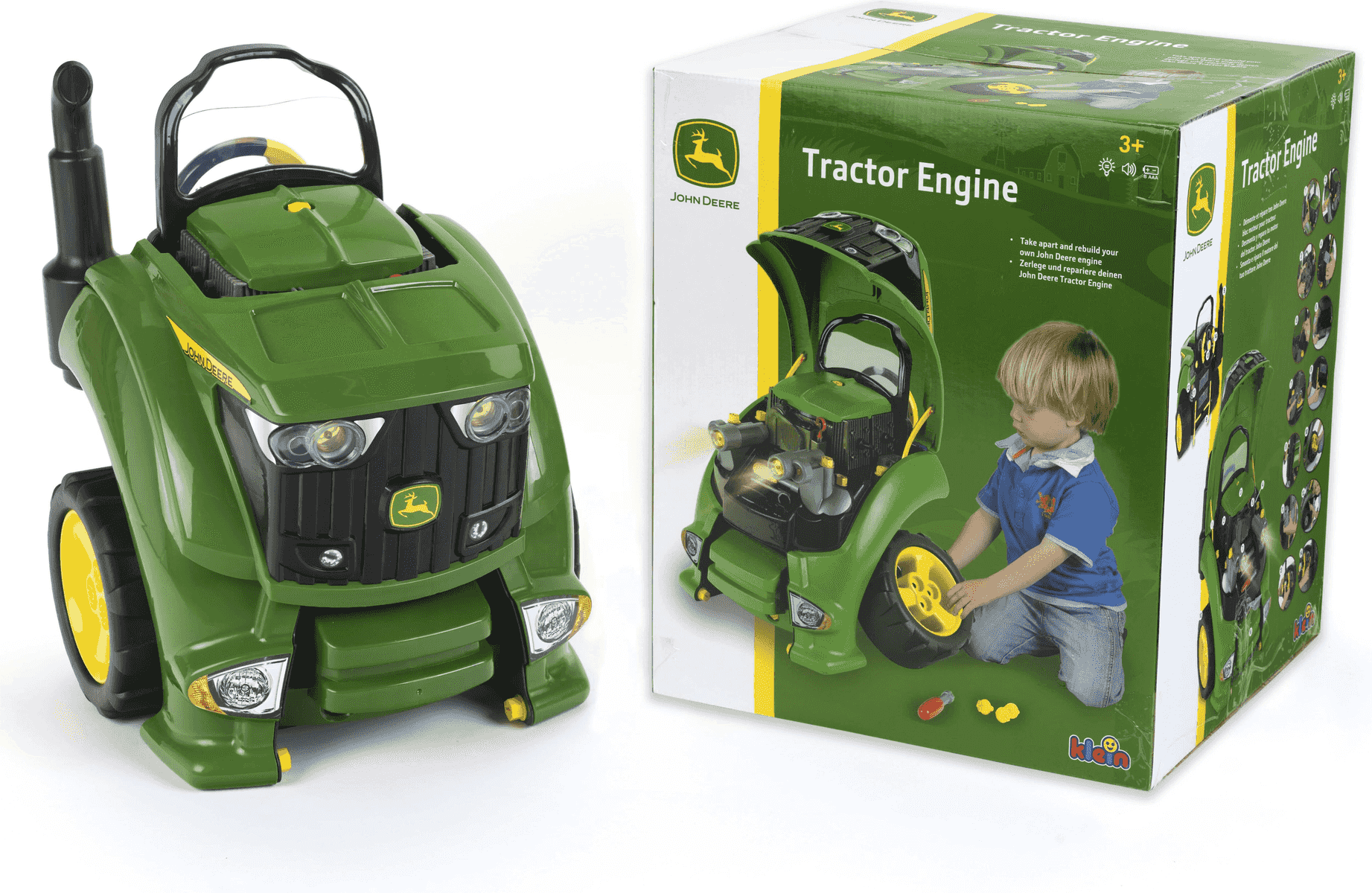 Un motor de tractor de juguete John Deere junto a su caja verde mostrando a un niño jugando.
