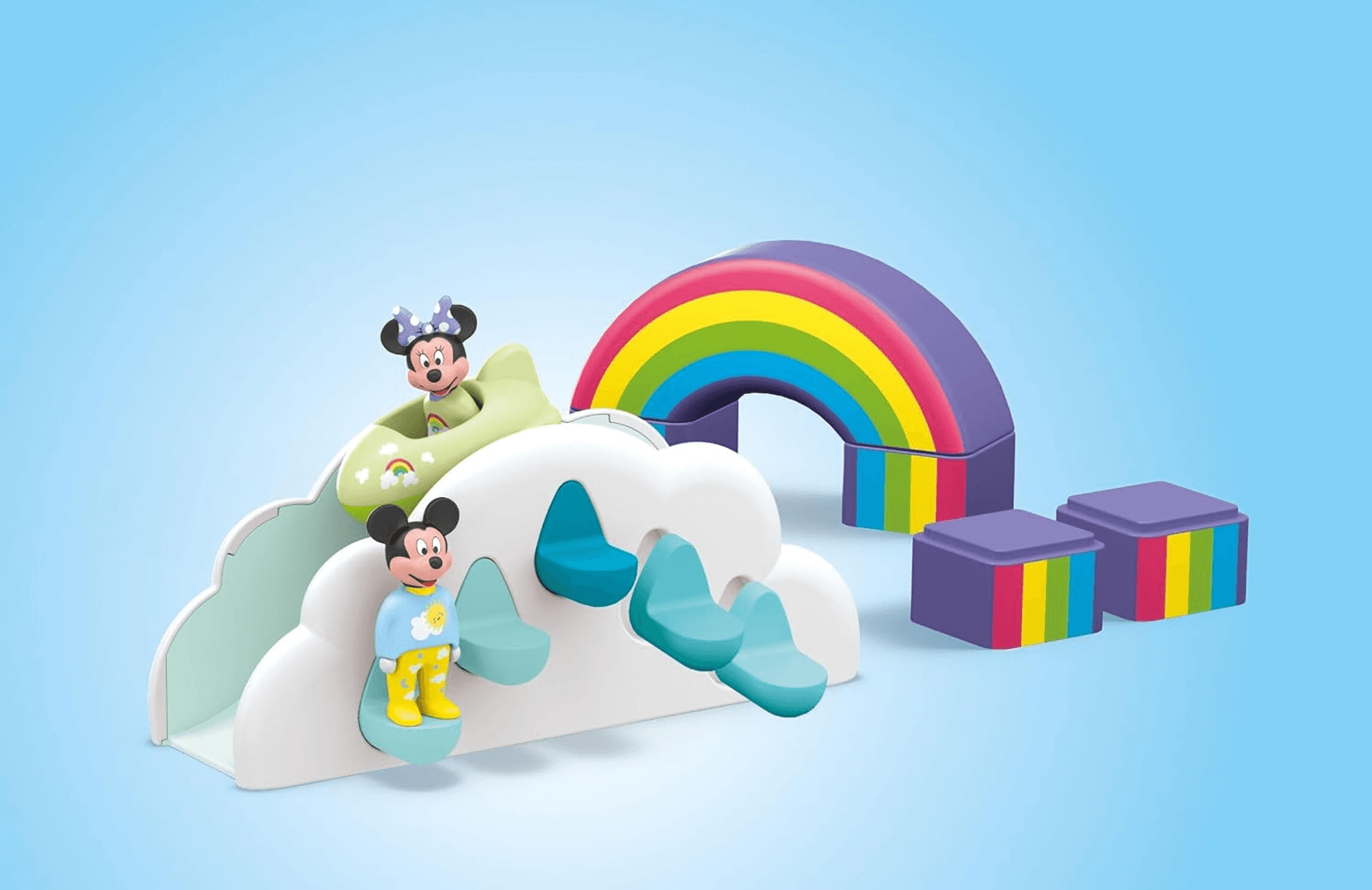 Set de juego de Mickey y Minnie Mouse con tobogán en forma de nube, arco iris colorido y bloques morados sobre fondo azul.