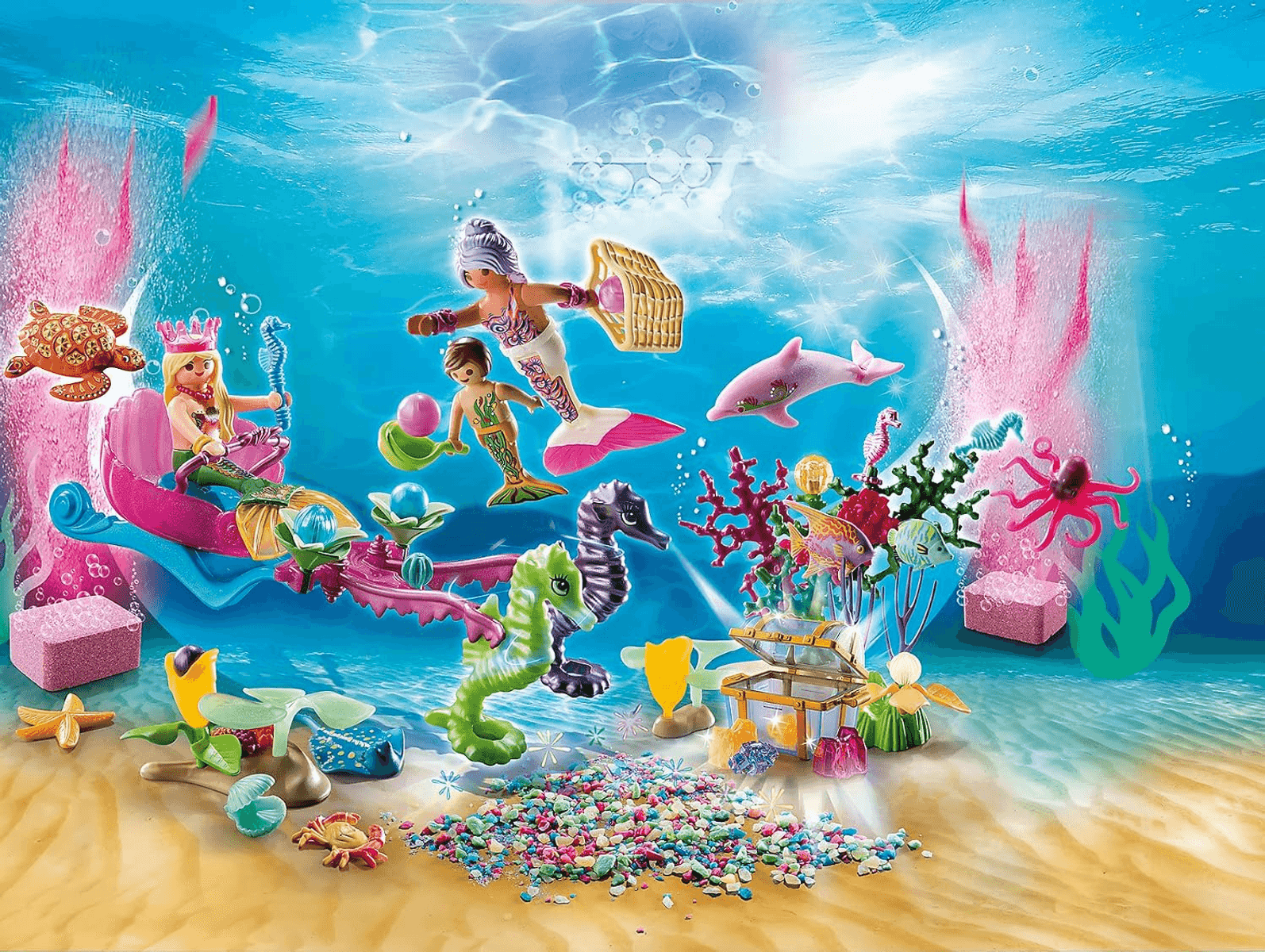 Sirenas de Playmobil y criaturas marinas bajo el agua con un cofre del tesoro, corales y guijarros.