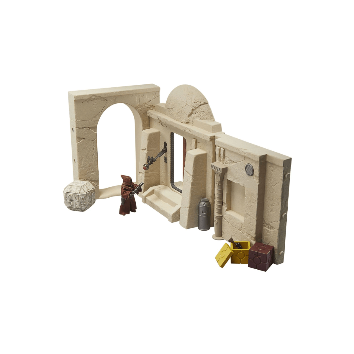 Un juego de arquitectura desértica de color arena con una pequeña figura de acción y varios accesorios.