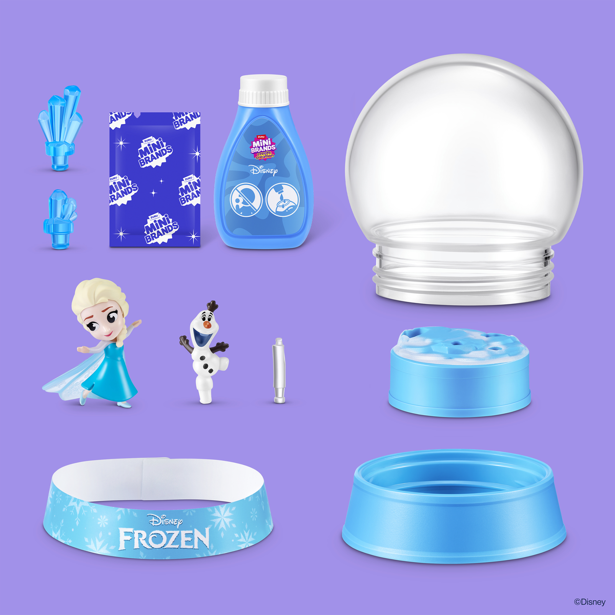 Set de Disney Frozen con Elsa, Olaf, cristales azules, botella, cinta y bola de nieve vacía sobre fondo morado.