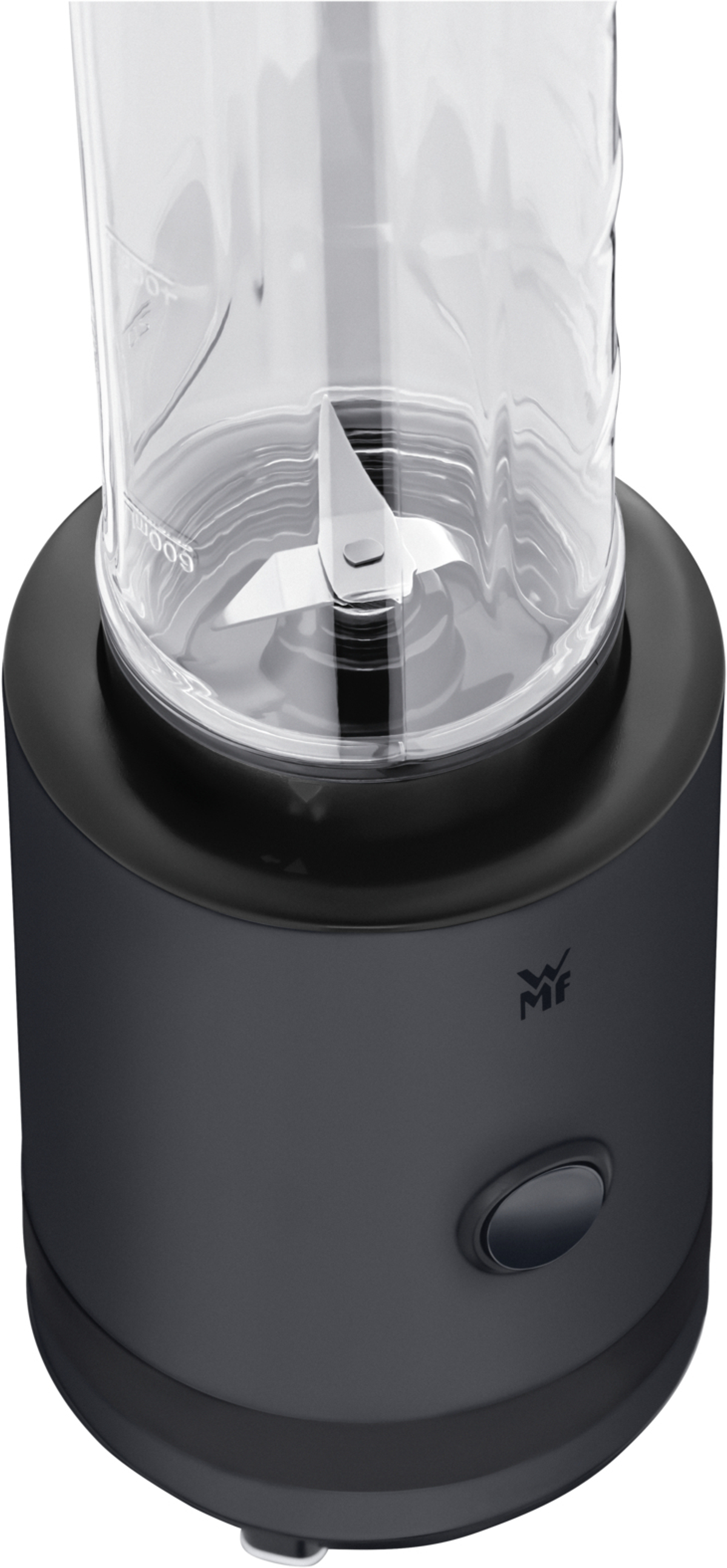 Un blender noir avec un récipient en verre transparent et des lames en acier inoxydable visibles, vu du dessus.