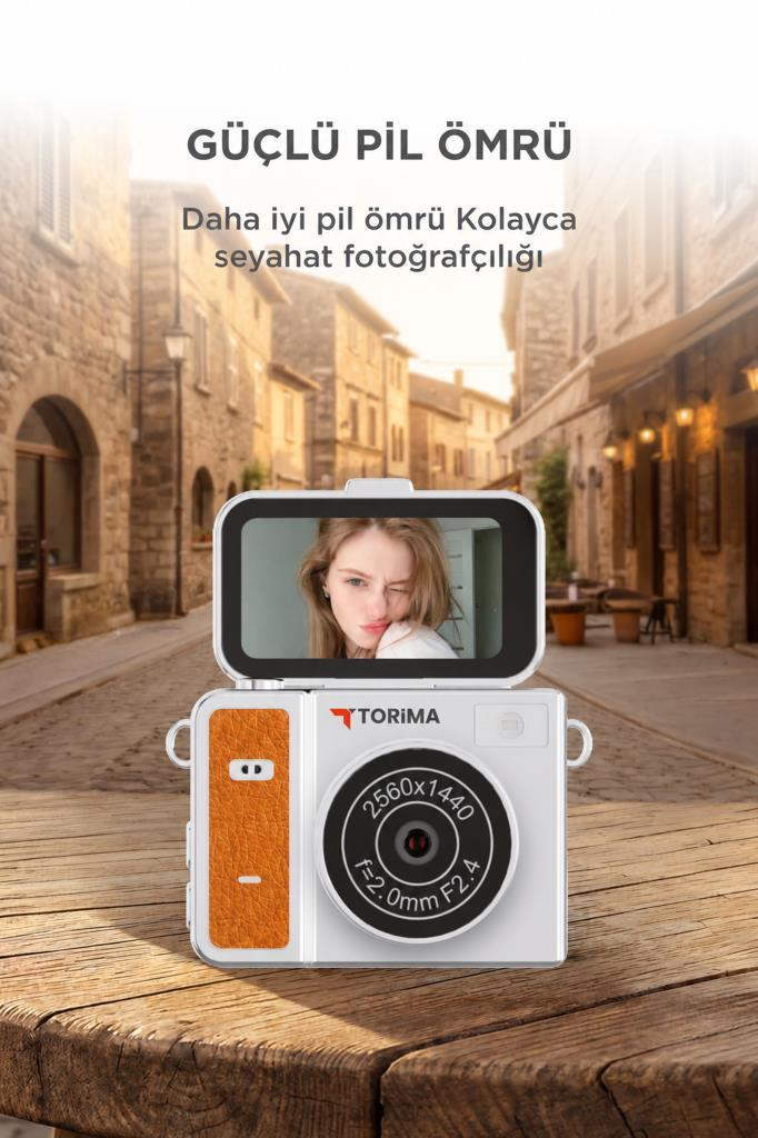 Ahşap masa üzerinde, eski bir sokak arka planında selfie ekranlı beyaz bir Torima kamera.