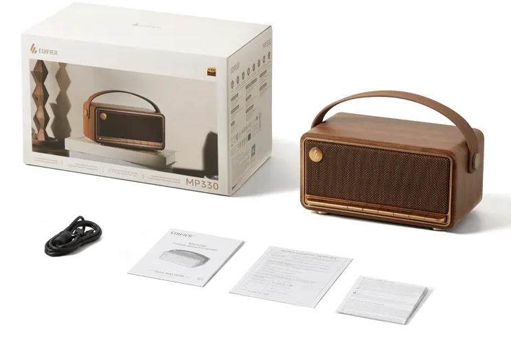 Głośnik Bluetooth MP330 w kolorze drewna z pudełkiem, kablem i instrukcjami na białym tle.
