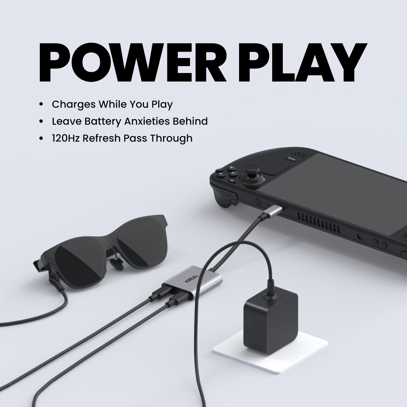 Una consola portátil conectada mediante adaptador a gafas AR y un cargador, con texto promocional arriba.