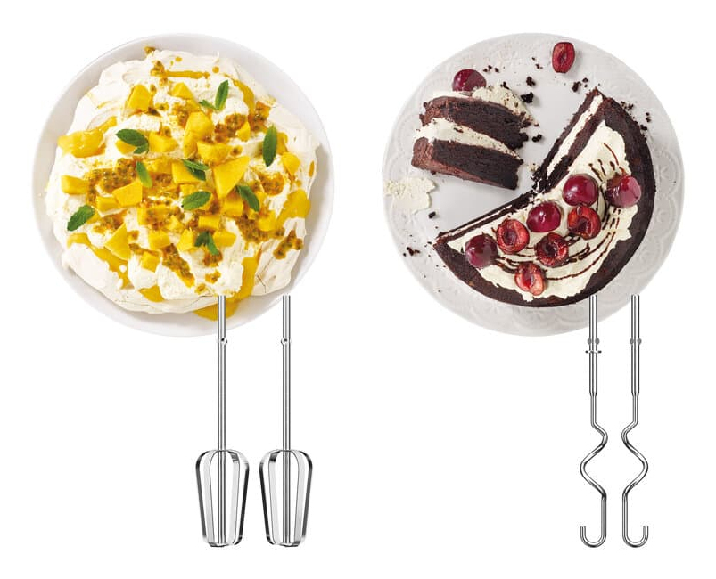 Zwei Teller mit Kuchen: links Pavlova mit Früchten, rechts Schokoladenkuchen mit Kirschen und Mixerrührstäben.