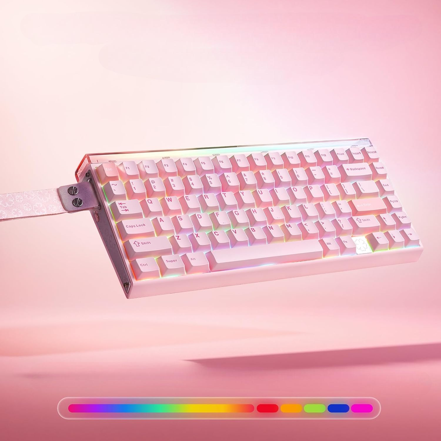 Różowo-biała klawiatura mechaniczna z podświetleniem RGB unosi się na różowym tle, po lewej stronie z paskiem.