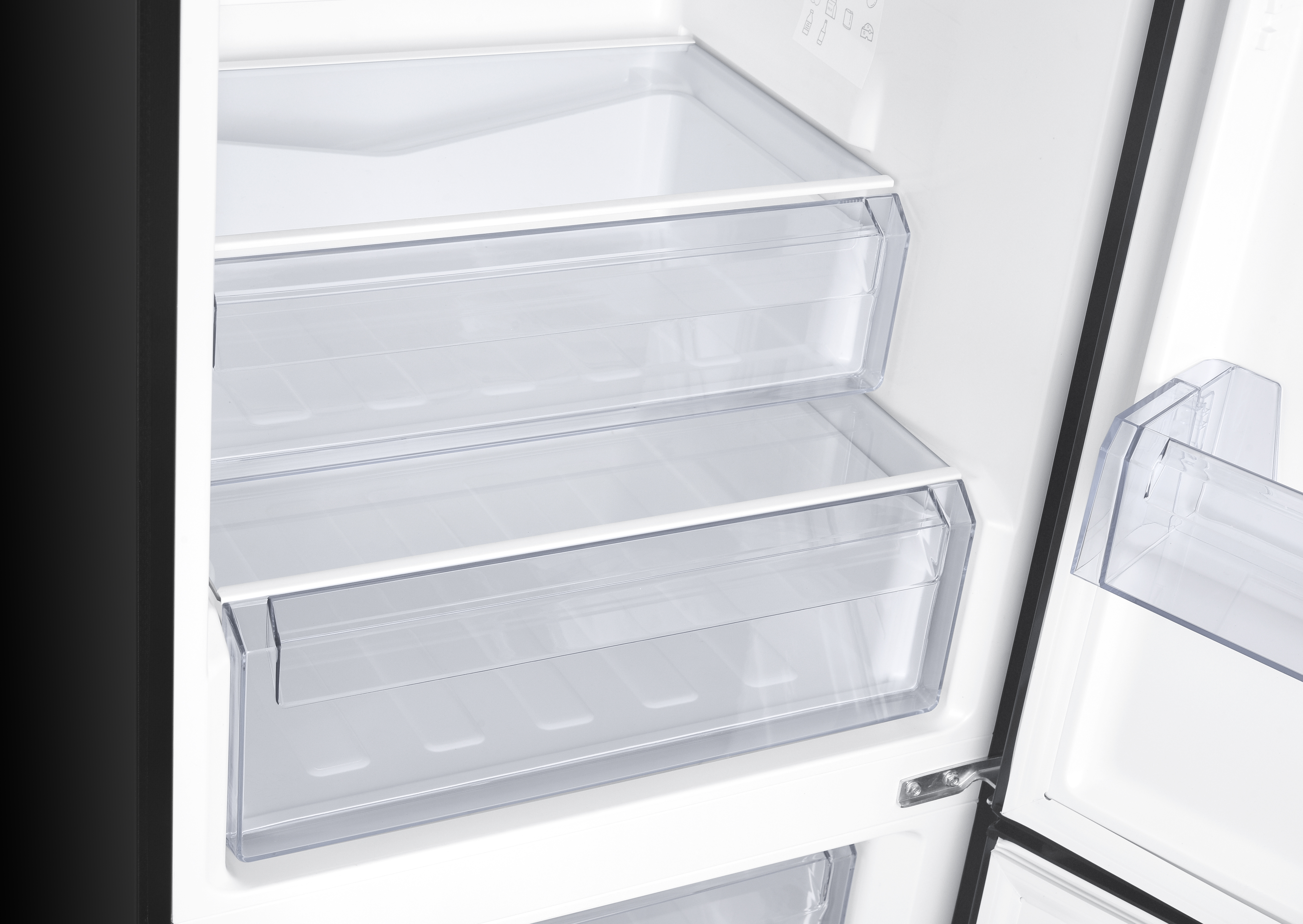 Inside view of an empty refrigerator with clear plastic drawers and shelves.