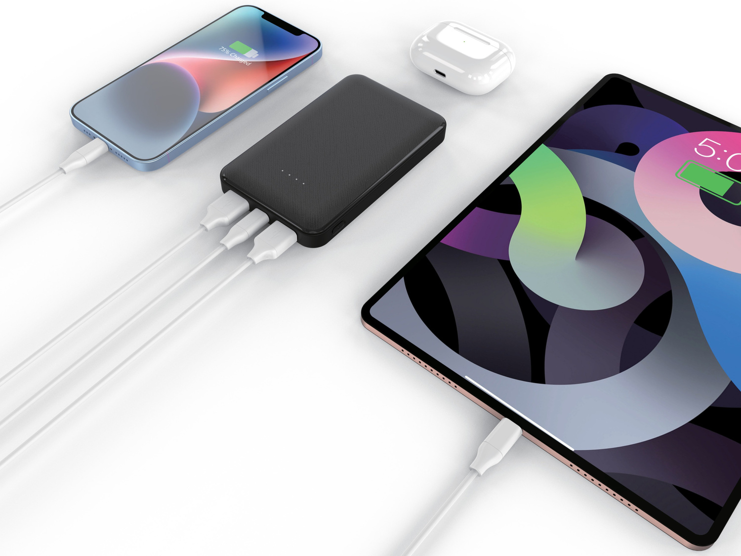 Czarny powerbank jest połączony białymi kablami z ładującym się smartfonem i tabletem.