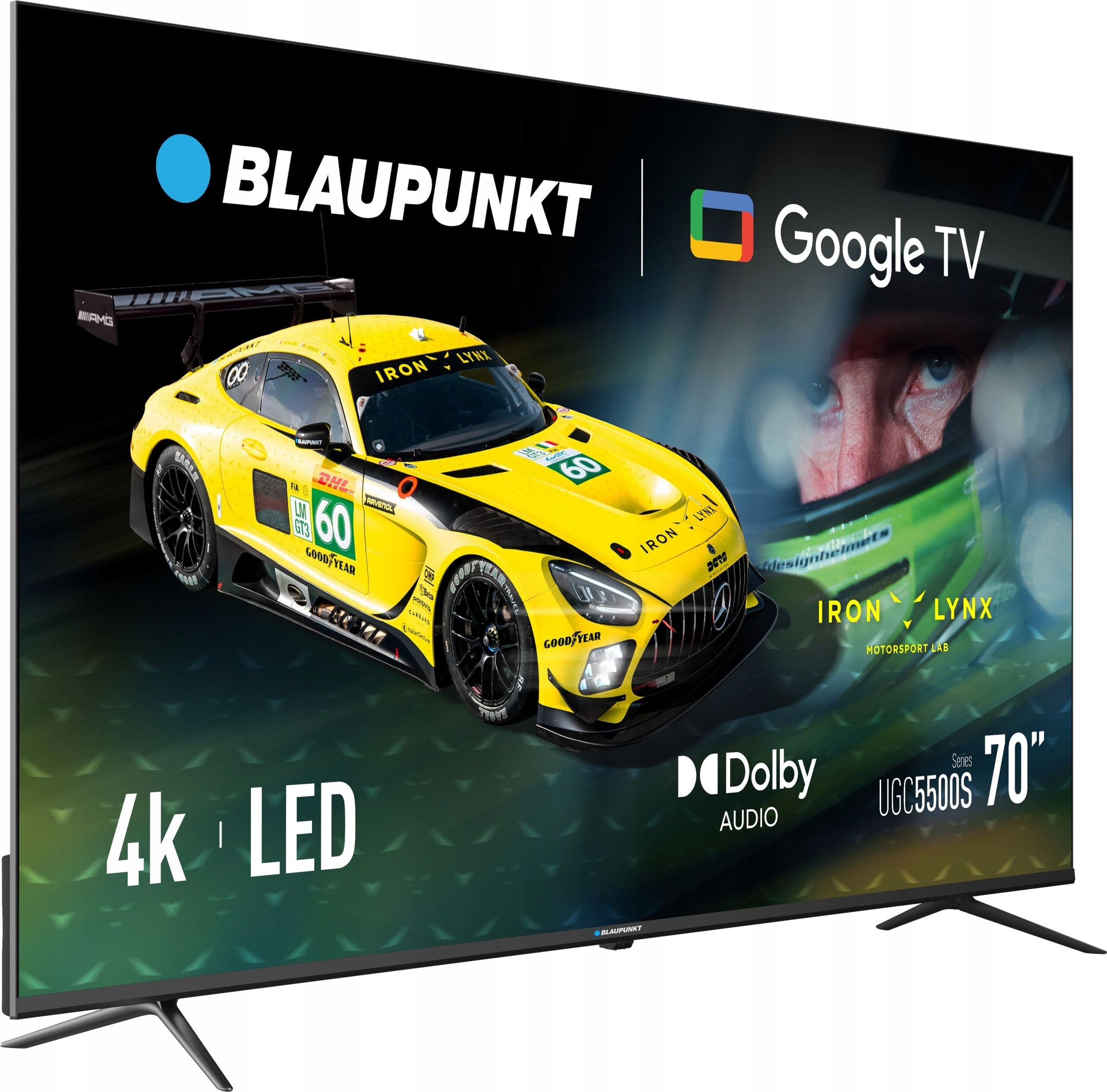 70-calowy telewizor Blaupunkt 4K LED Google TV wyświetla żółty samochód wyścigowy i twarz kierowcy w kasku.