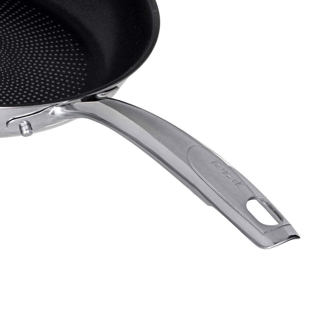 Close-up of a silver Tefal frying pan handle with a metallic finish and a hanging hole at the end.