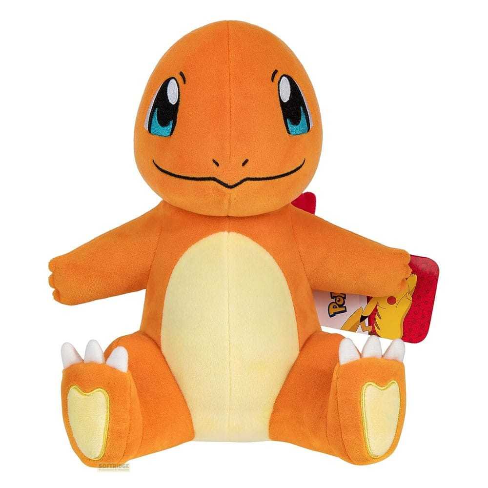 Ein sitzendes, orangefarbenes Charmander-Stofftier mit blauen Augen und hellem Bauch.