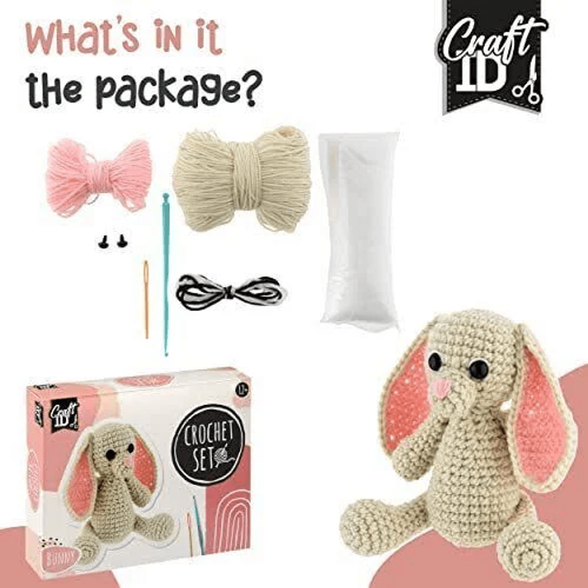 Un juego de ganchillo con hilo, agujas y accesorios, además de un elefante de ganchillo terminado y su caja.