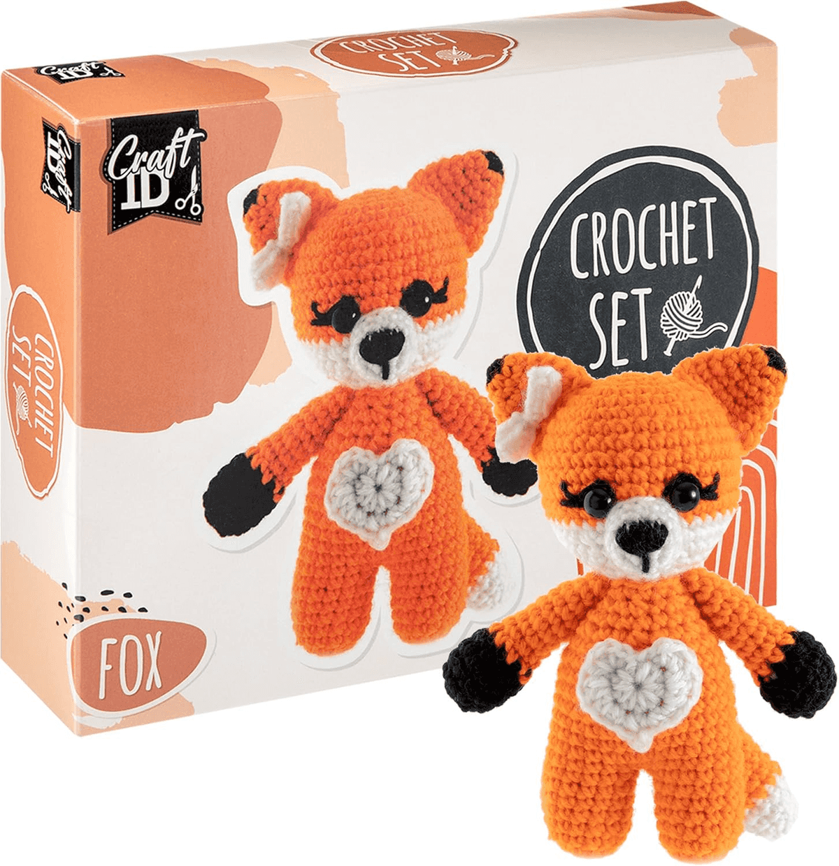 Una caja de set de ganchillo con un peluche de zorro naranja y blanco delante.