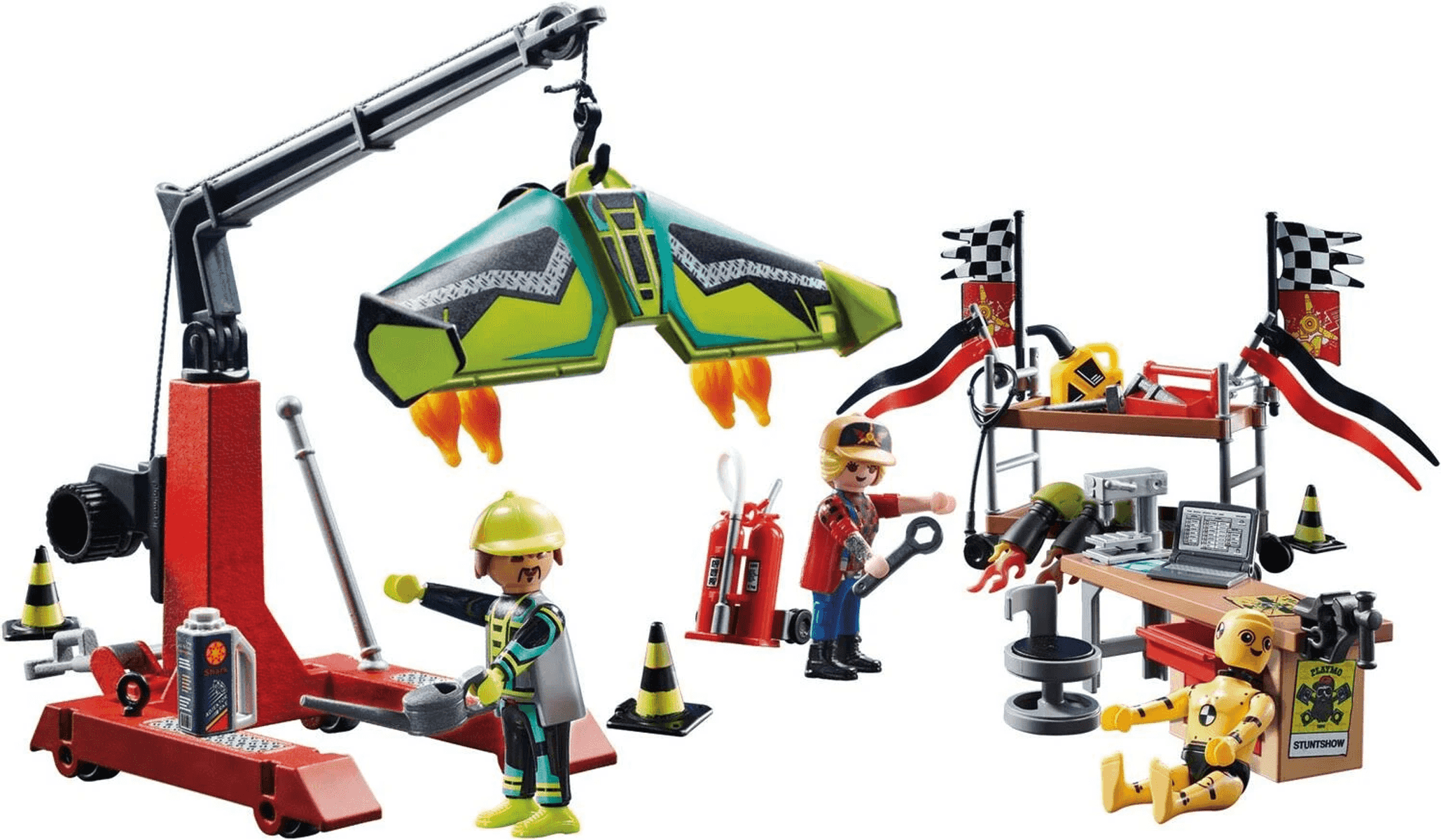Set de acrobacias Playmobil con grúa, taller, piezas de vehículos, figuras y un maniquí.