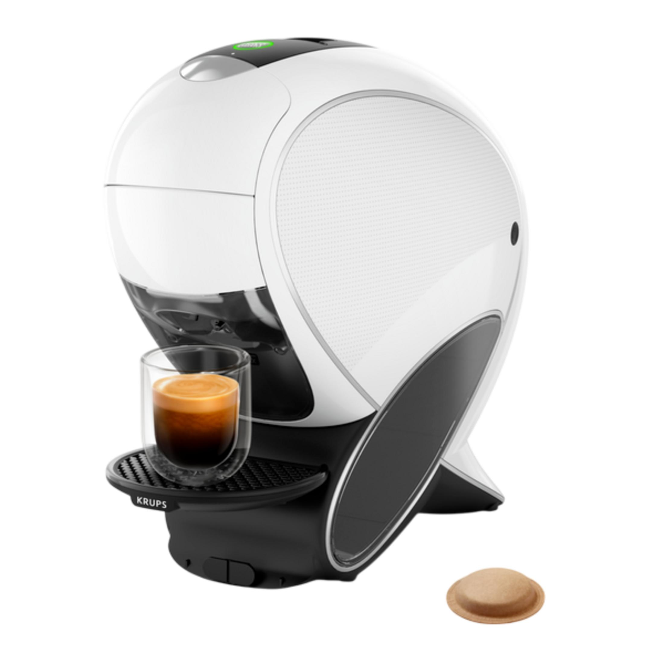 Macchina da caffè Krups bianco-nera con un bicchiere di espresso sul vassoio raccogligocce e una cialda.