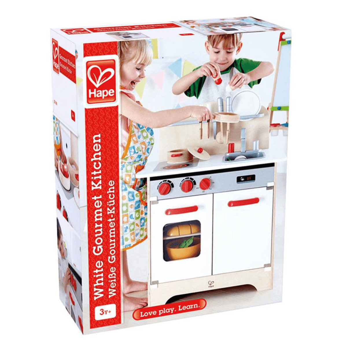 Empaque de la cocina de juguete blanca Hape Gourmet con dos niños jugando con ella.