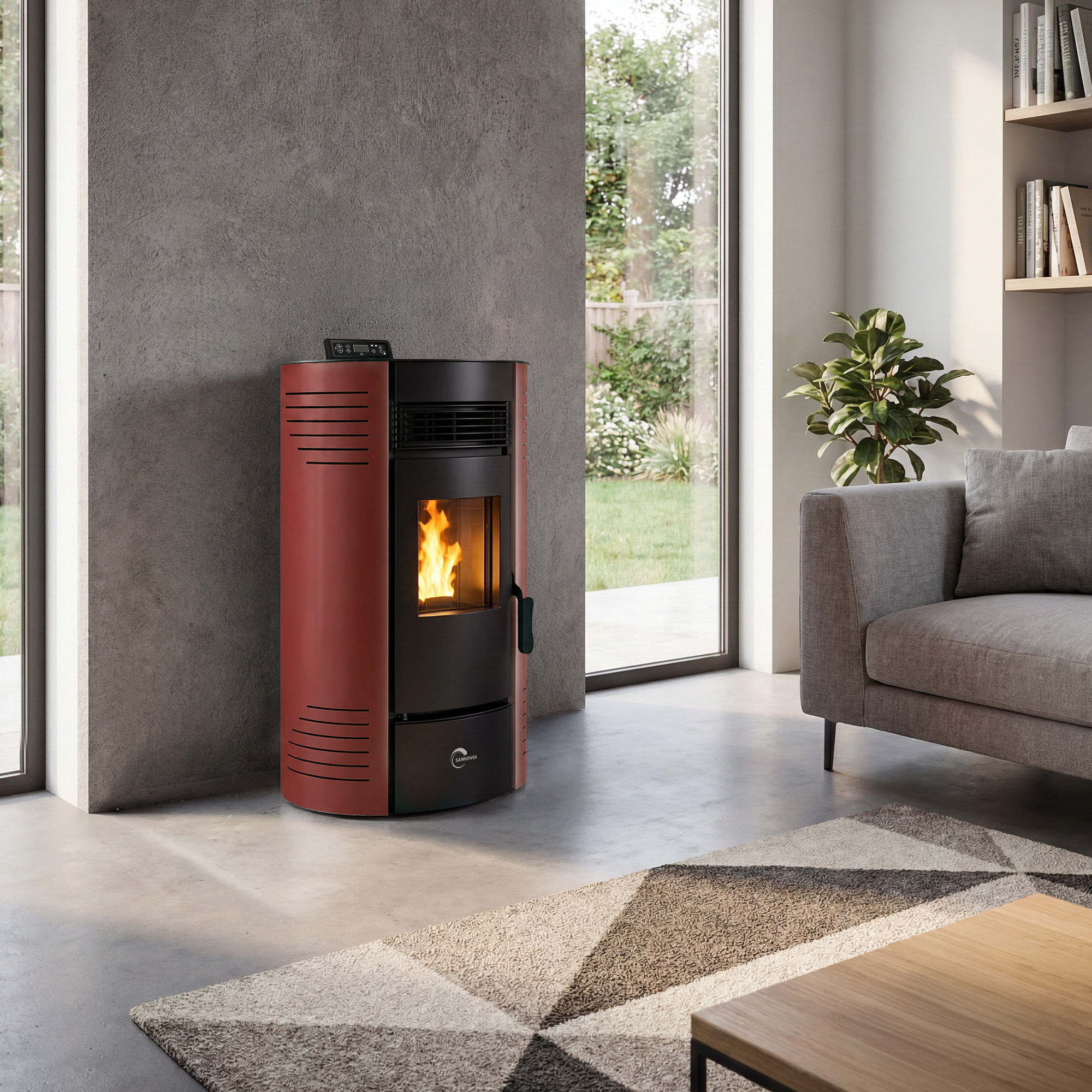 Una estufa de pellets roja y negra en una sala de estar moderna con un sofá gris y un ventanal.