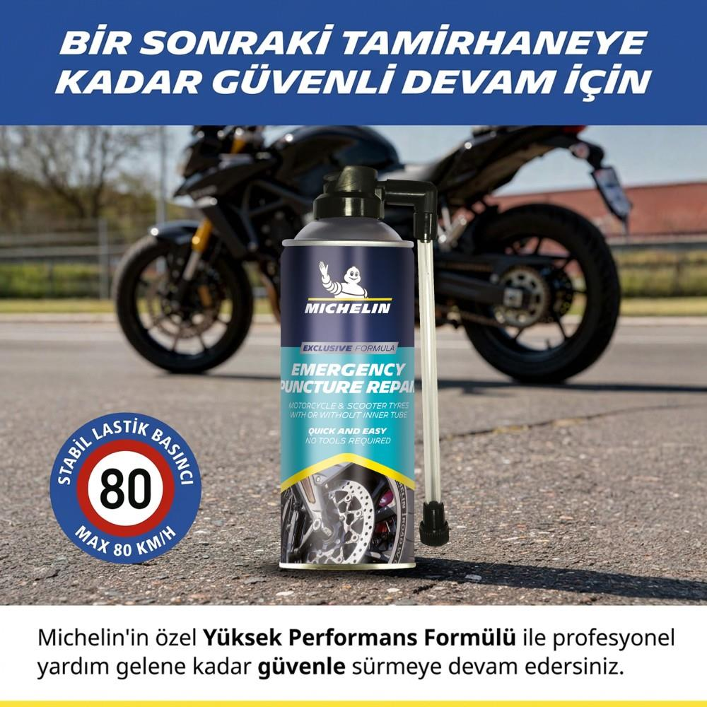 Arka planda bulanık bir motosikletle asfalt yolda duran Michelin lastik tamir spreyi.
