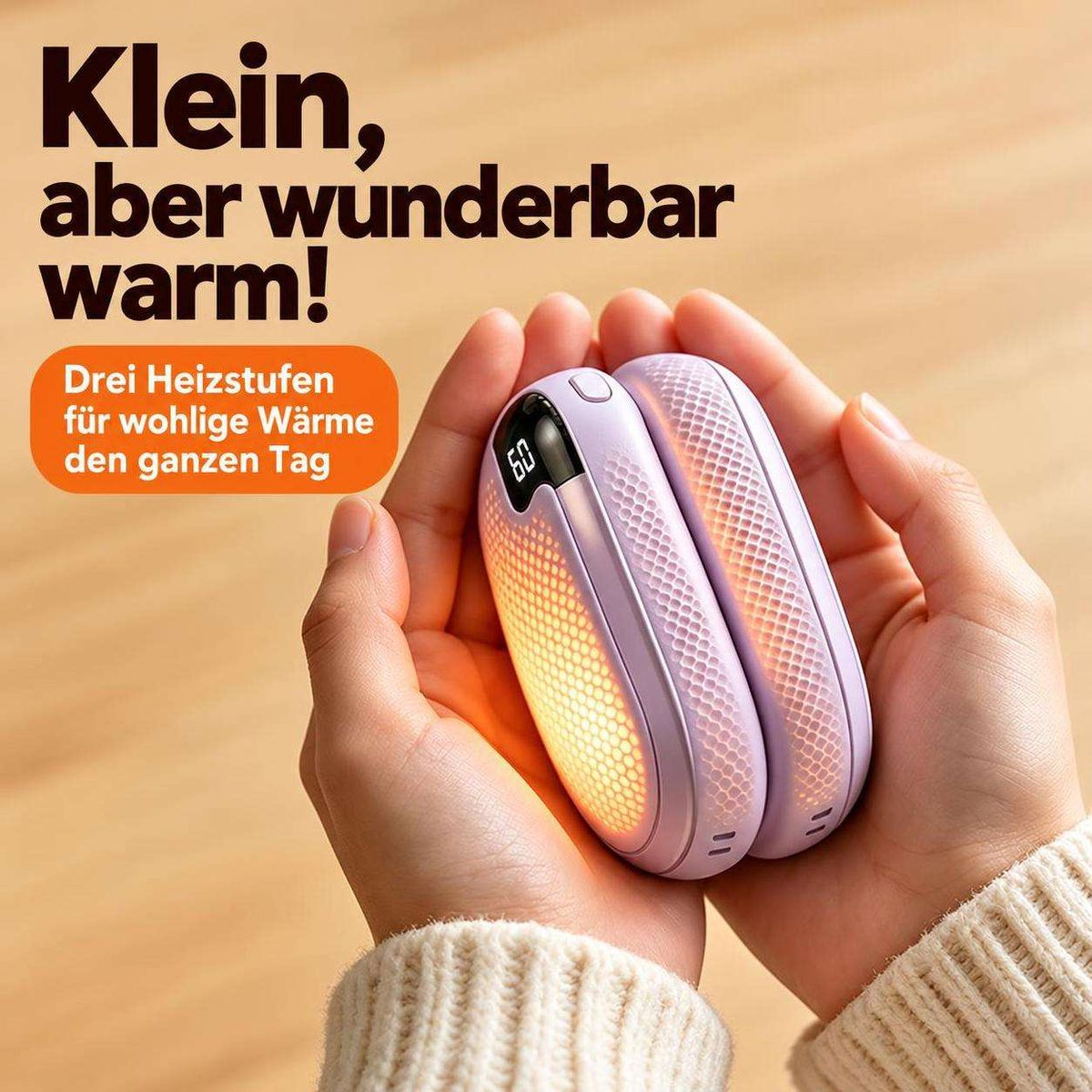 Zwei Hände halten ein kompaktes, lila Handwärmegerät mit leuchtender Anzeige und orangefarbenem Licht.