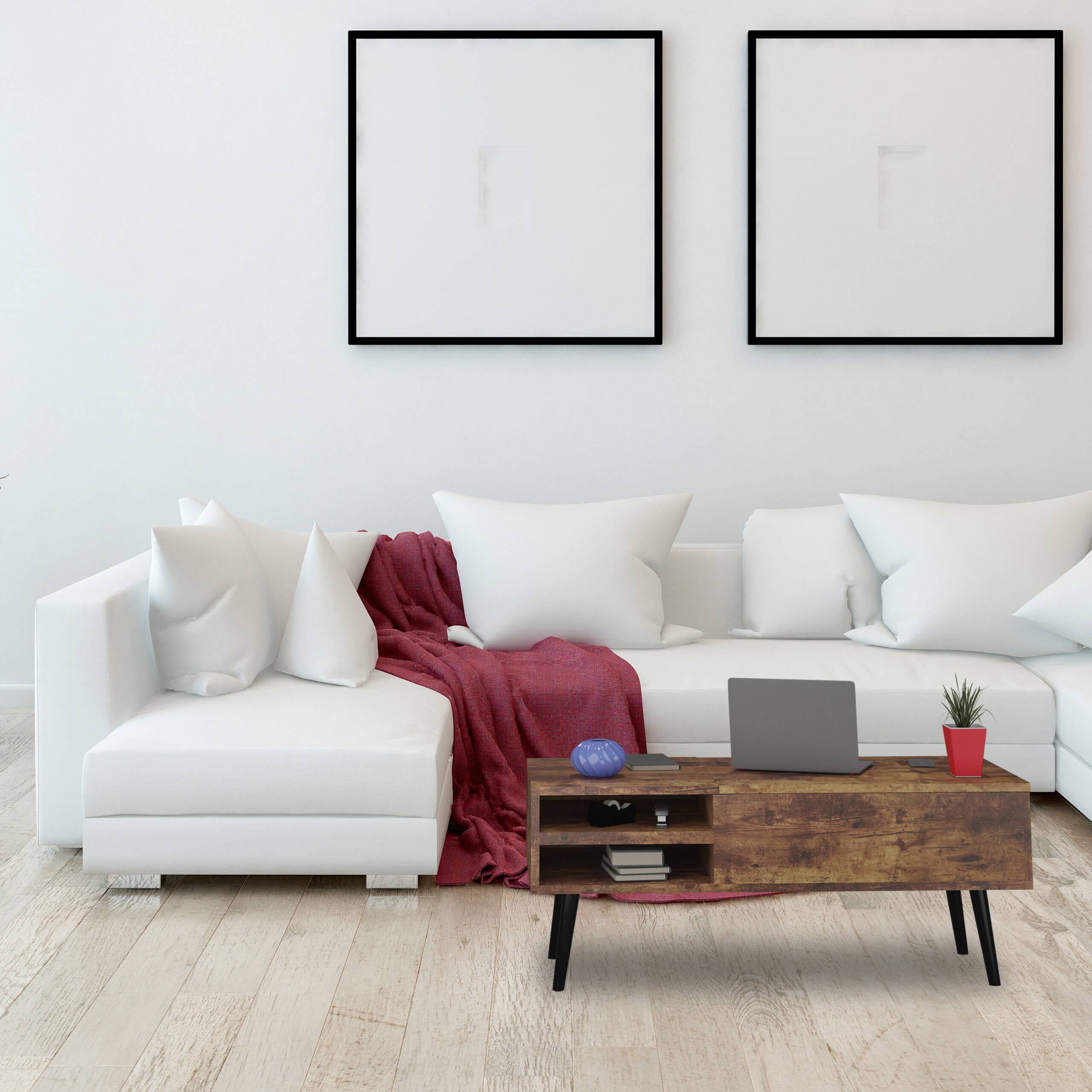 Ein weißes Ecksofa mit roter Decke steht vor einer weißen Wand, mit zwei Bildern und einem Holztisch.