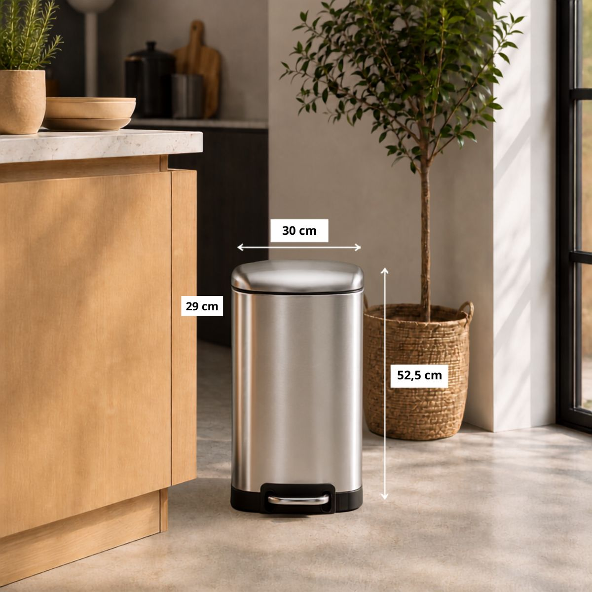 Silver step-on trash can in kitchen with dimensions 30 cm, 29 cm, and 52.5 cm.