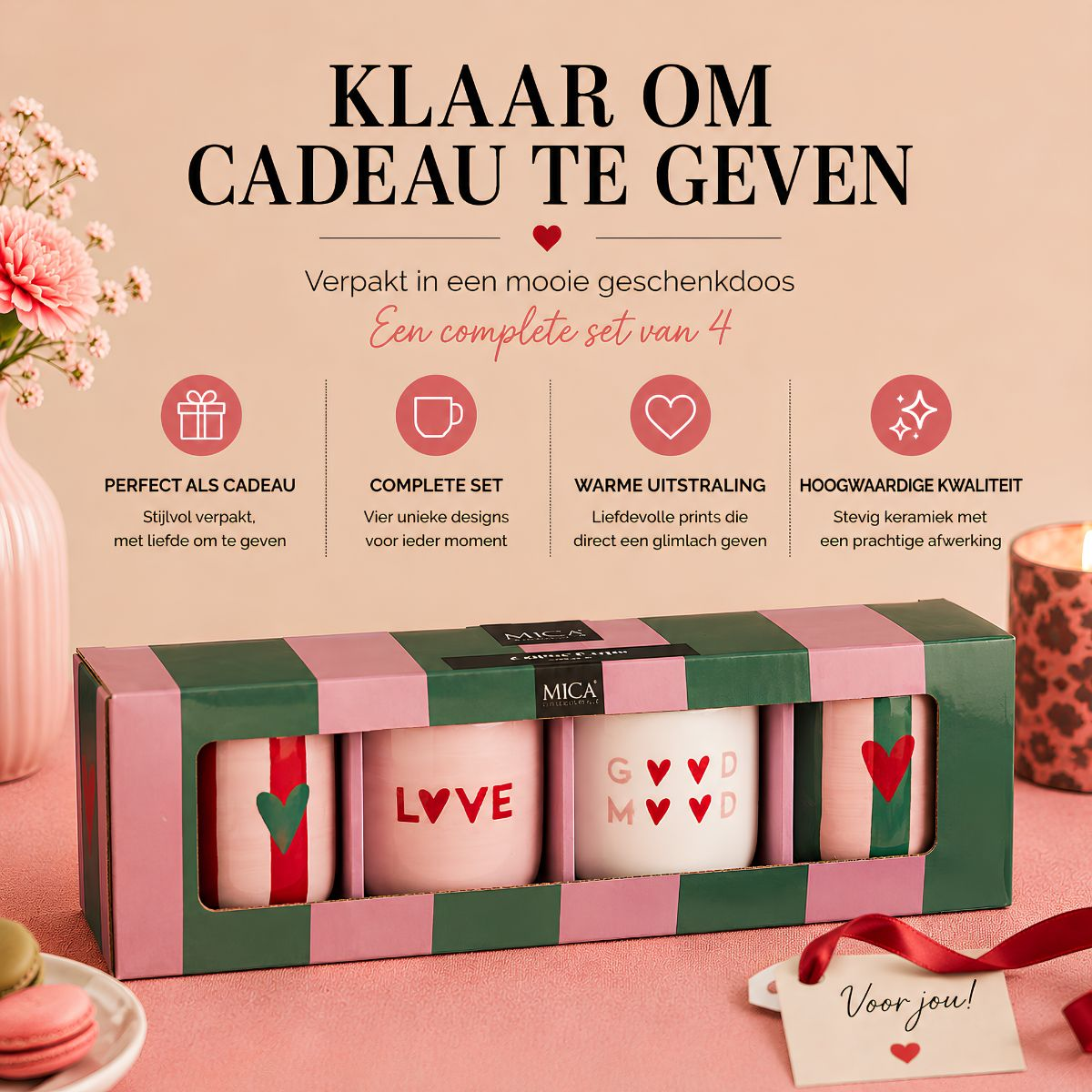 A gift box with four ceramic mugs featuring heart designs, displayed on a pink surface with Dutch promotional text.