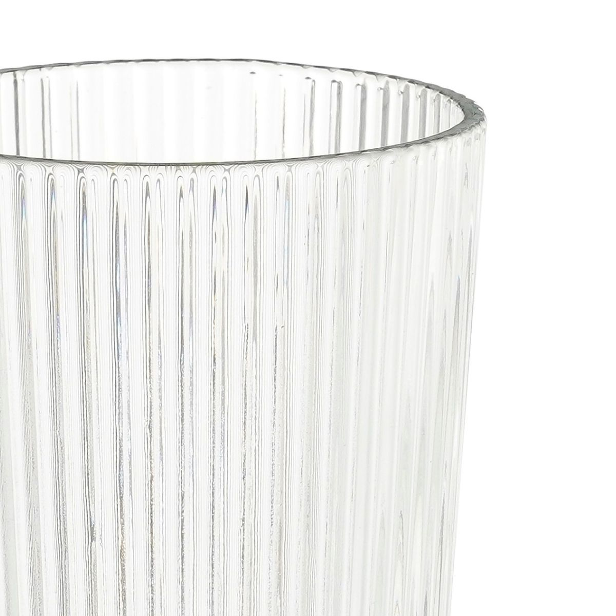 Close-up of the ribbed texture of a transparent glass tumbler against a white background.
