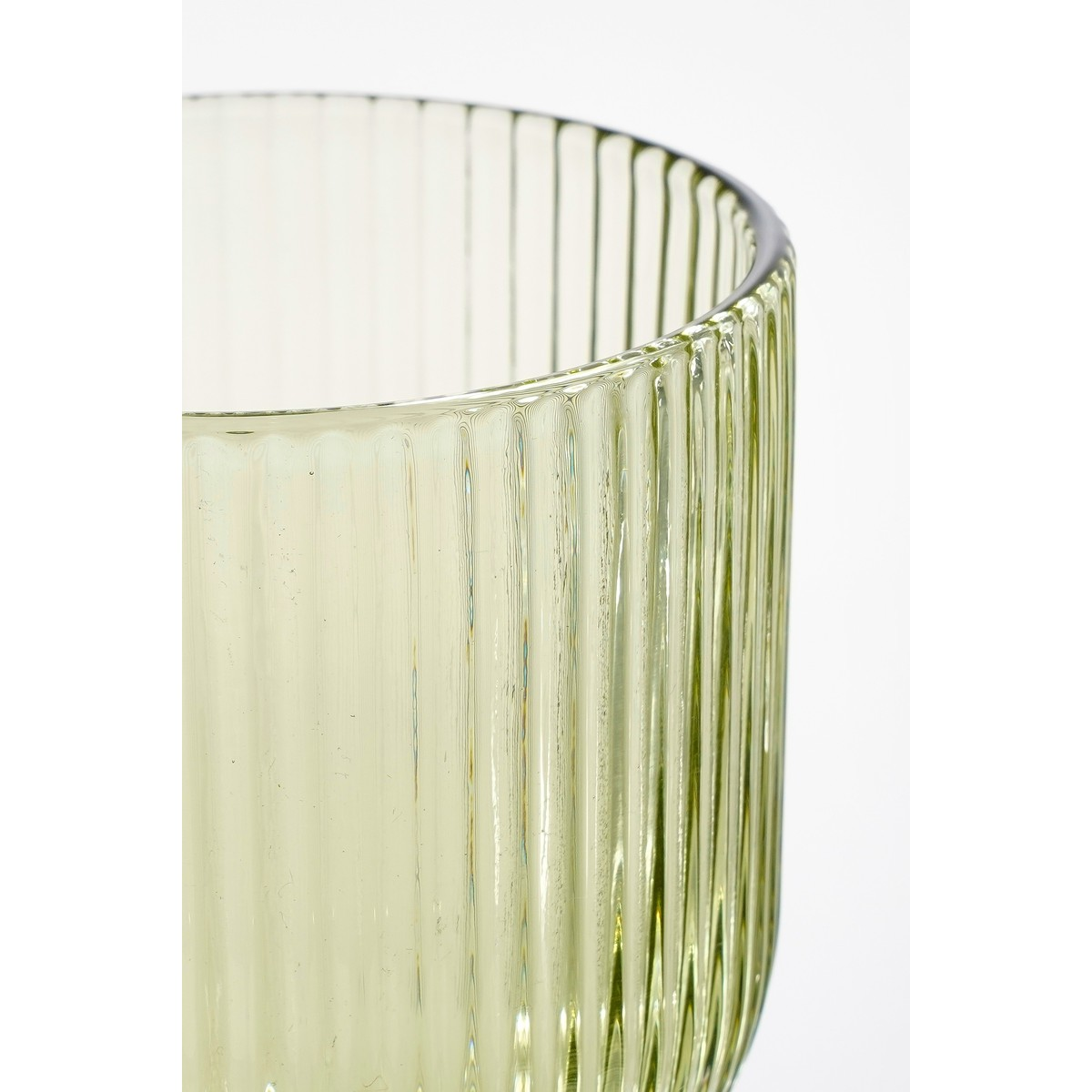 A close-up view of a ribbed light green glass vase against a white background.