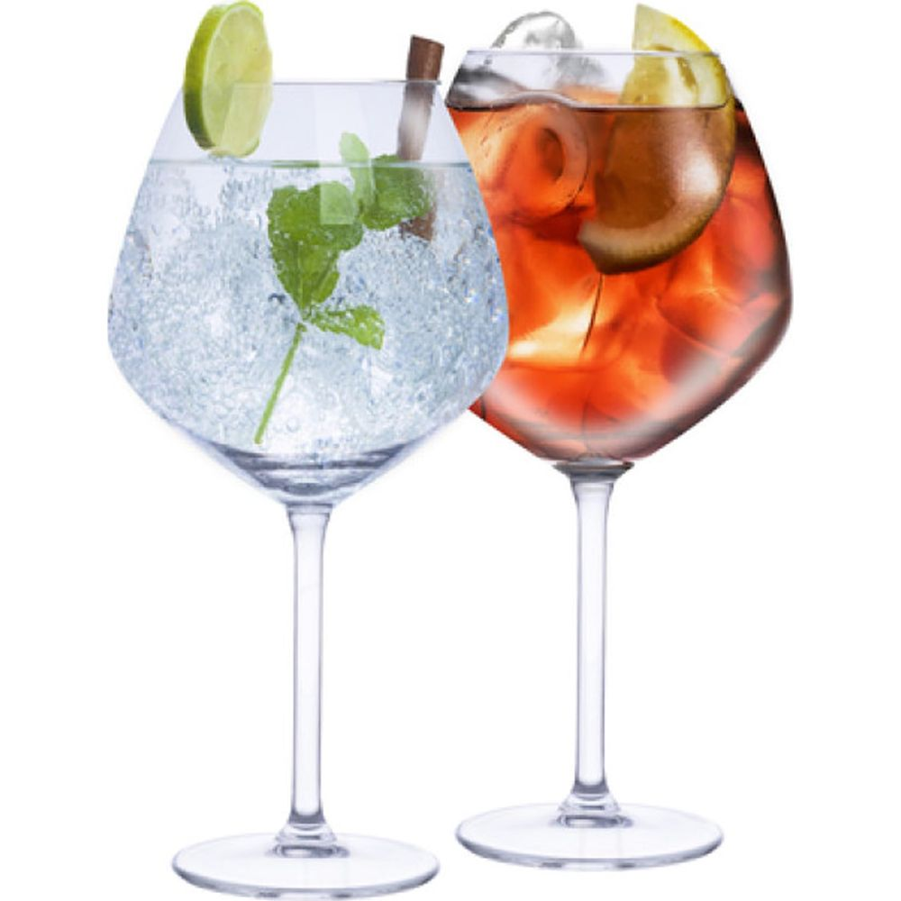 Two large wine glasses with cocktails, one with gin and tonic, mint, and lime, the other with an orange drink and lemon slice.