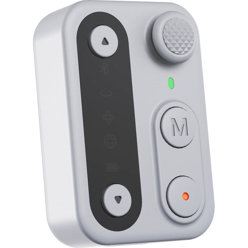 Telecomando bluetooth portatile bianco con pulsanti rotondi, ghiera, LED di stato e pannello centrale nero su sfondo bianco.